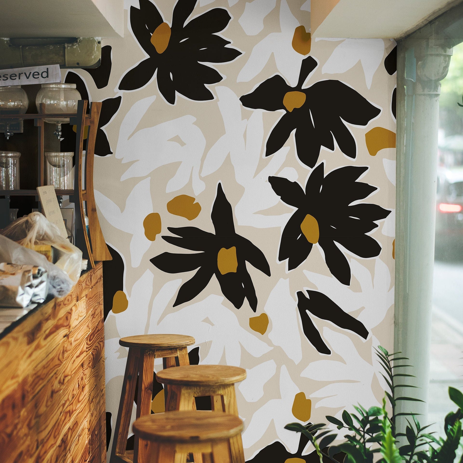 After Midnight dark floral wallpaper styled in a studio with warm wood, brass, and black accents.