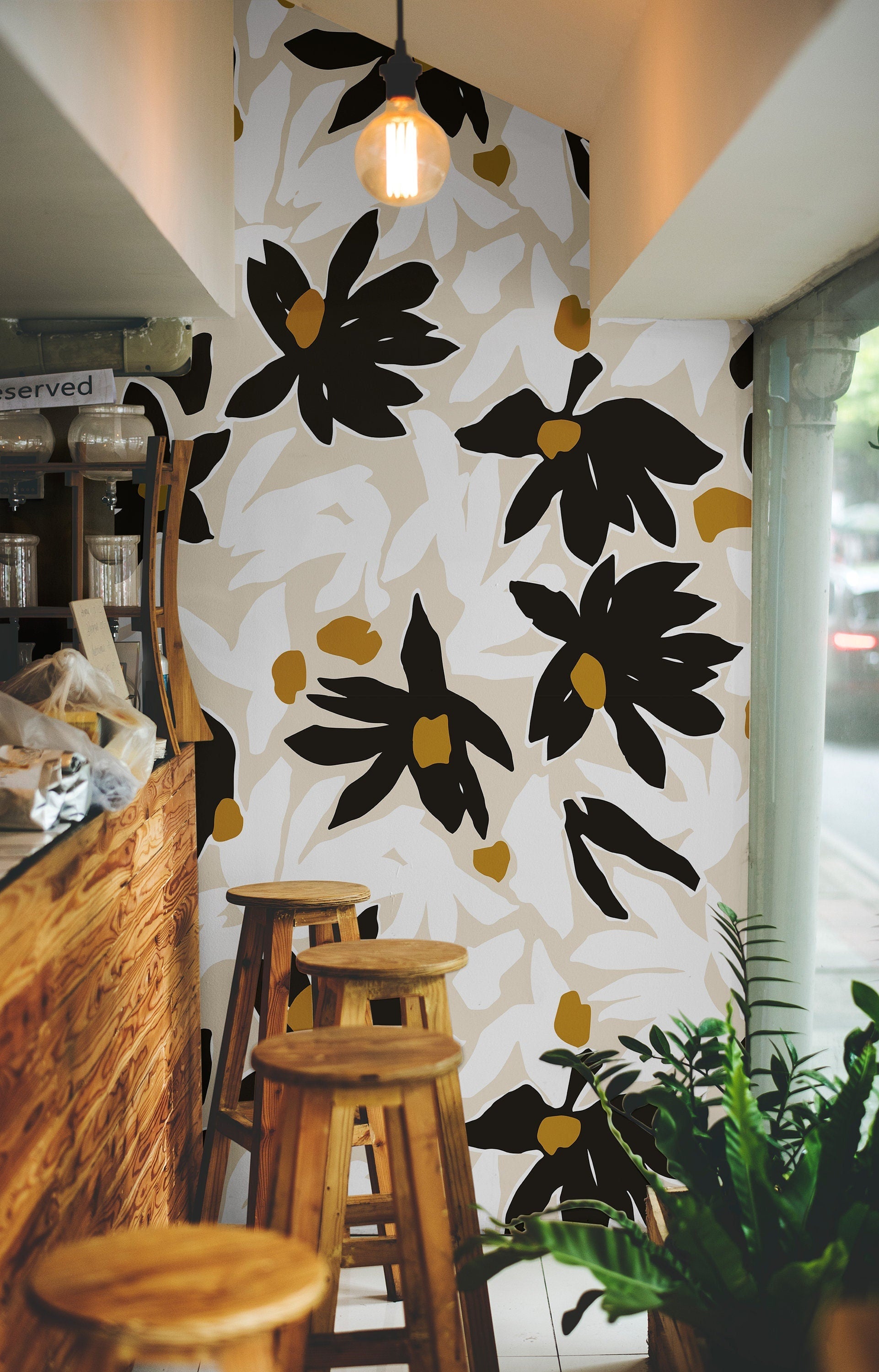 After Midnight dark floral wallpaper styled in a studio with warm wood, brass, and black accents.