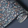 Contact Paper 116: A dark terrazzo-style contact paper featuring scattered speckled stone patterns in earthy tones of brown, beige, and blue, creating a modern, industrial-inspired aesthetic.