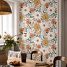 The Heiress Garden large floral wallpaper creating a warm botanical statement wall in a cozy dining room.