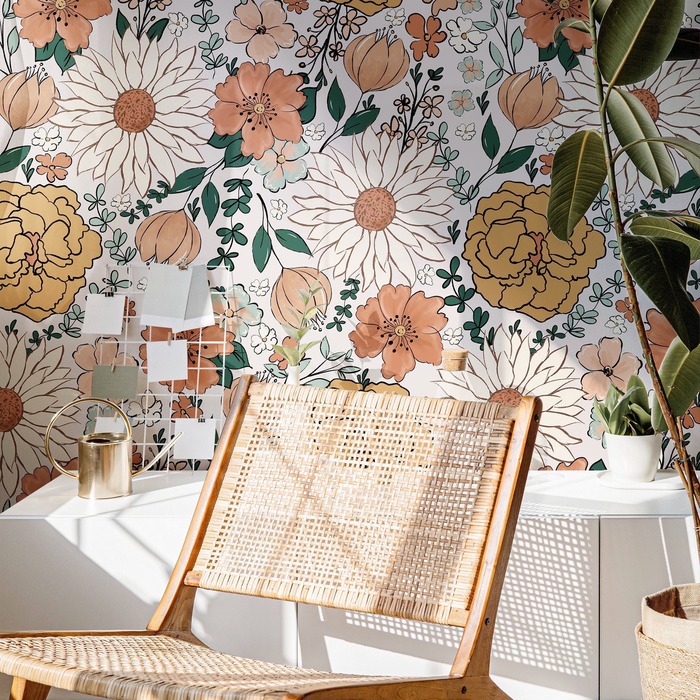 The Heiress Garden vintage floral wallpaper with peach, gold, and green blooms in a warm living room.
