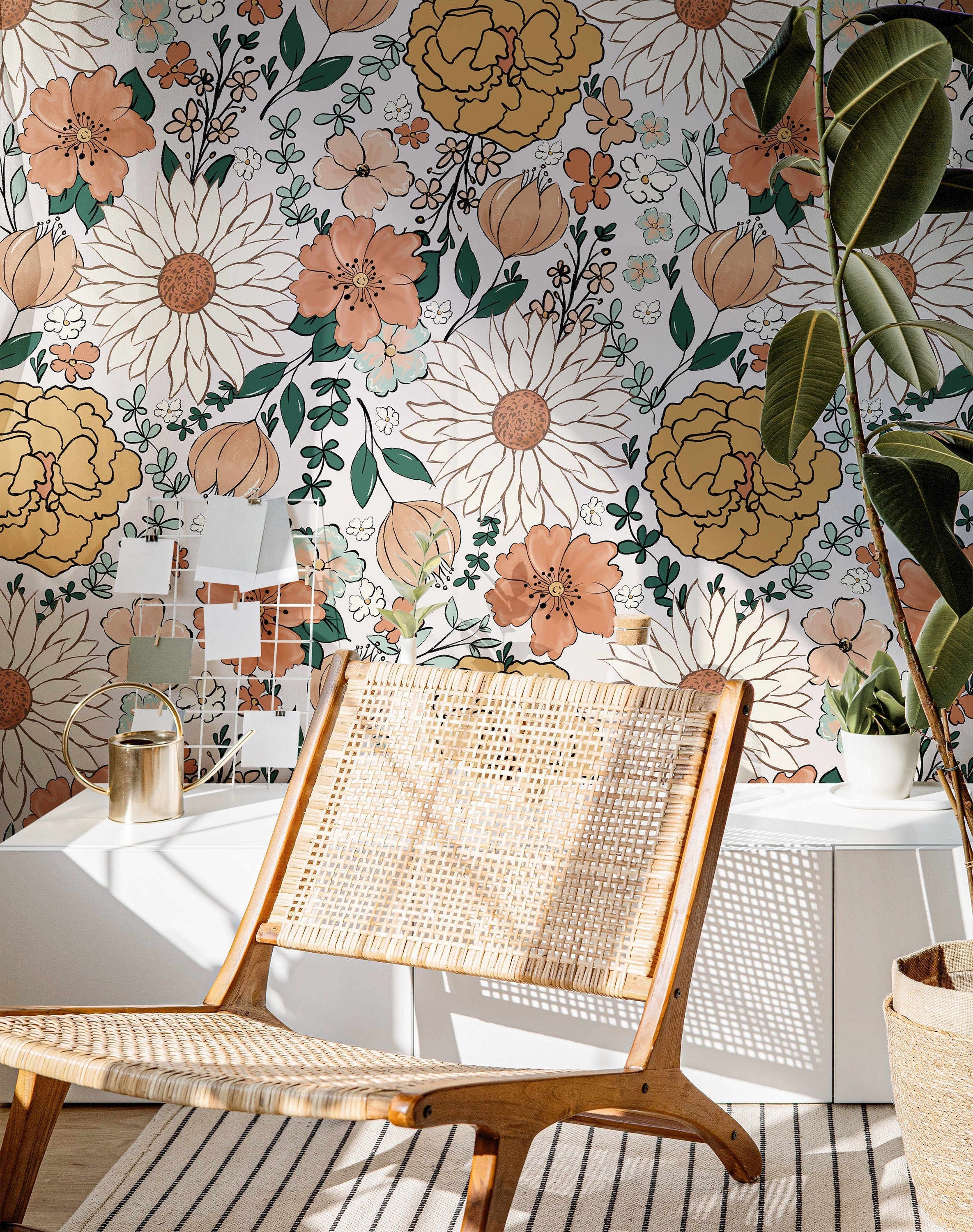 The Heiress Garden vintage floral wallpaper with peach, gold, and green blooms in a warm living room.
