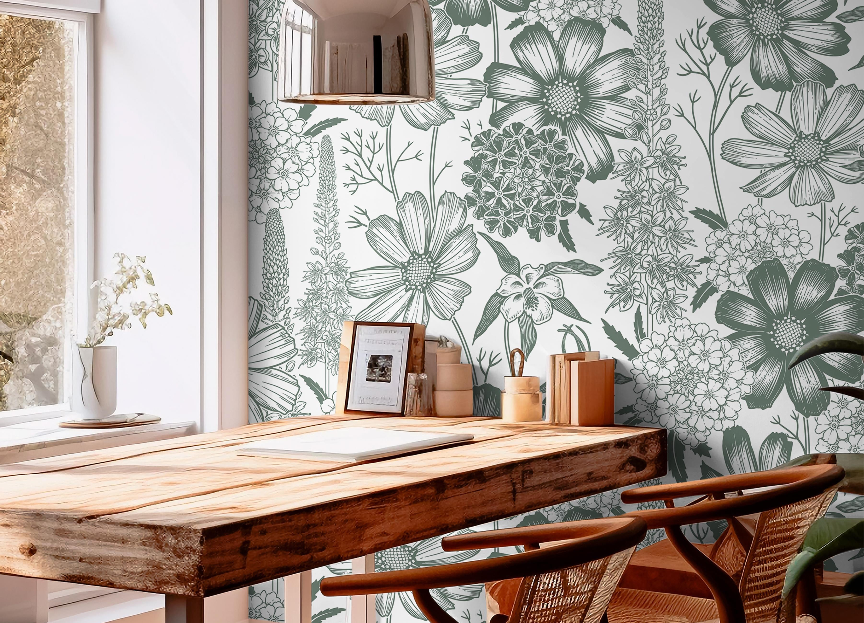 Wallpaper 1458: Large-scale sage green botanical illustration wallpaper with wildflowers and stems on a white background, styled behind a wood desk with natural lighting and woven chairs.