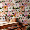 Overlapping pink , yellow, orange, white, and cream flowers as a wallpaper design.