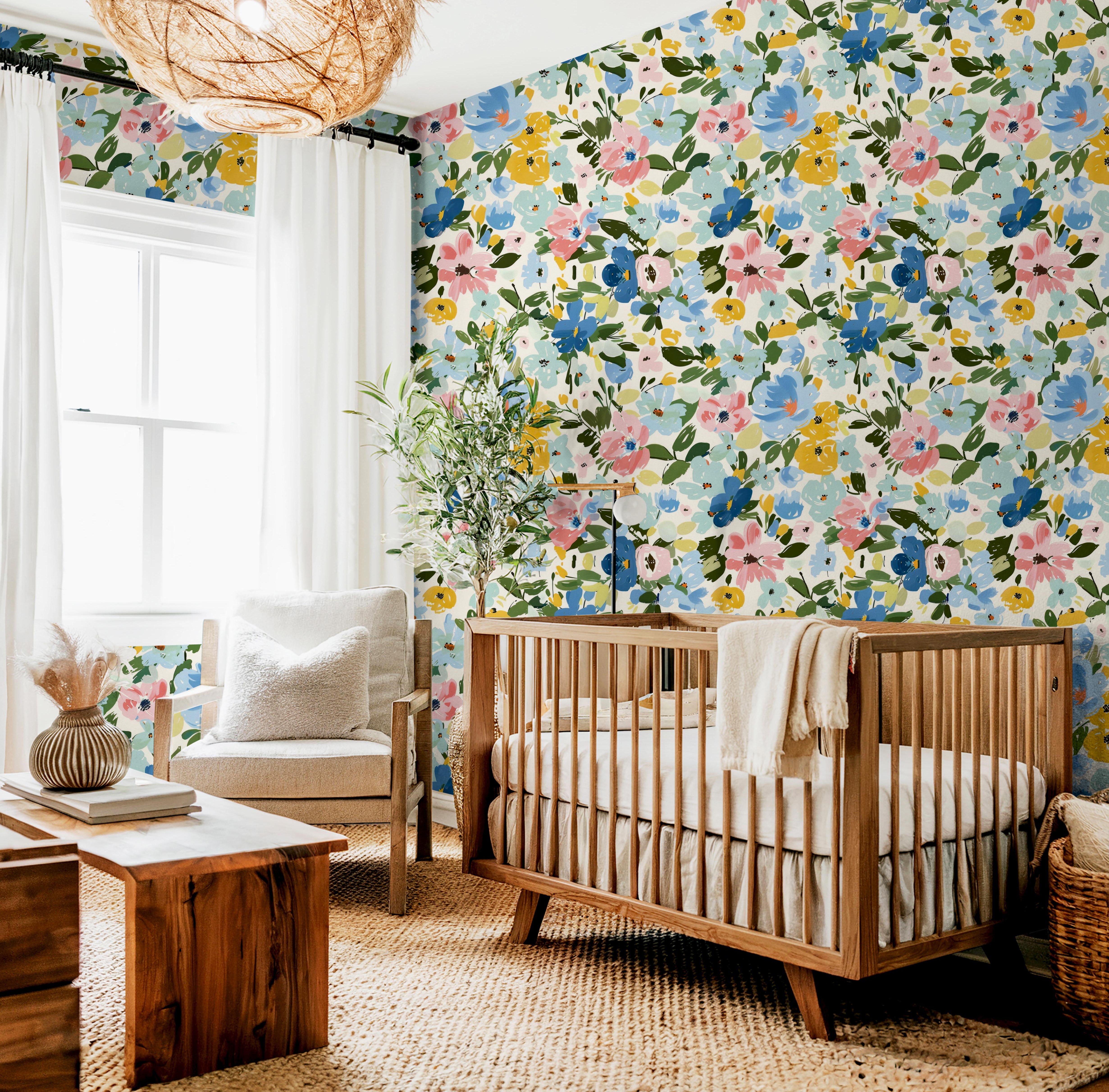 Wallpaper 1648: A vibrant floral wallpaper featuring hand-painted watercolor flowers in shades of blue, pink, and yellow with lush green leaves. The large-scale botanical design creates a statement wall, perfect for nurseries, bedrooms, and accent spaces.