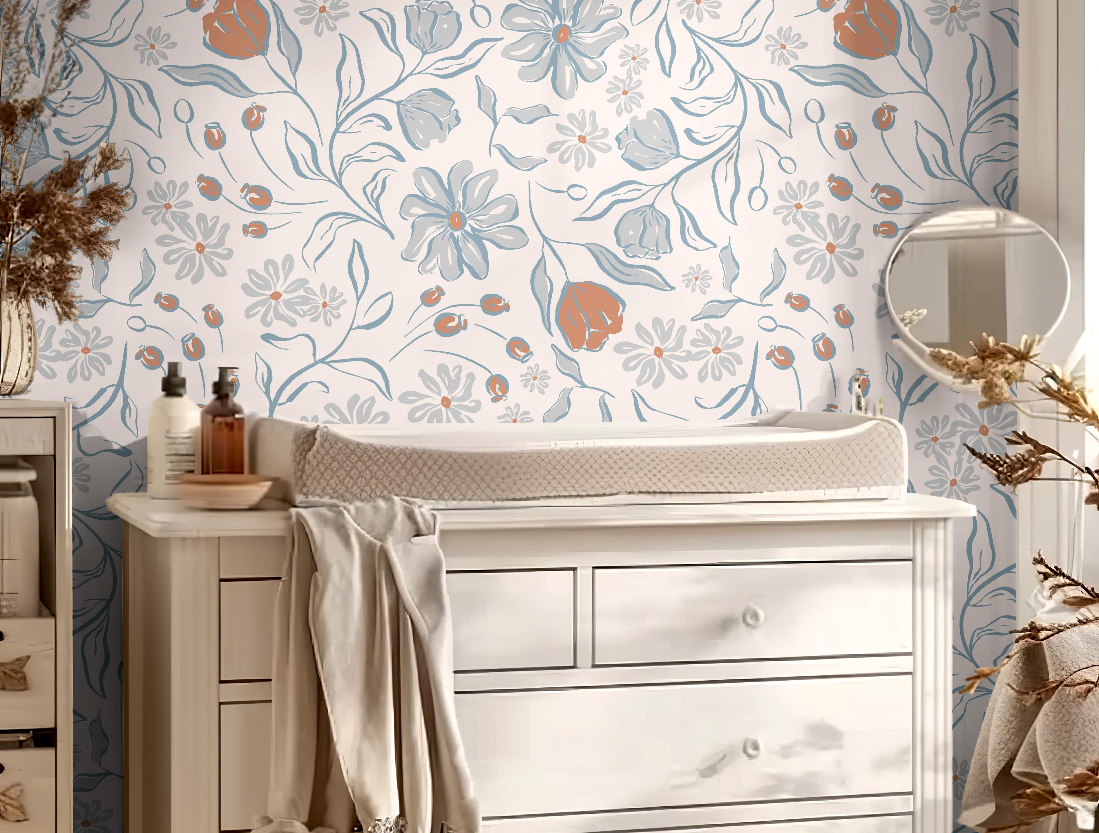 Wallpaper 1655: Soft floral wallpaper with hand-drawn blue, rust, and gray flowers in a nursery behind a white changing table and dresser, styled with warm neutral tones and natural light.