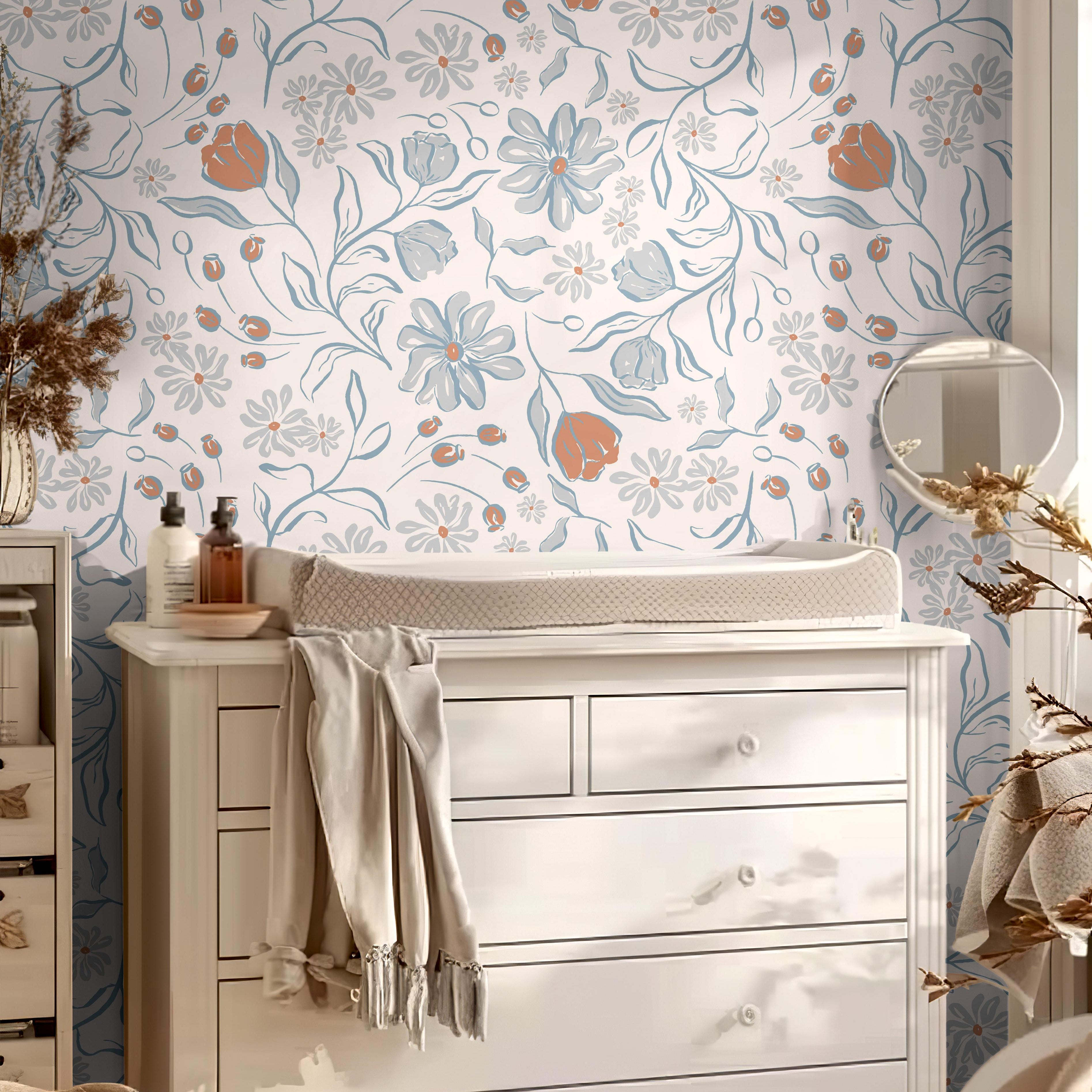 Wallpaper 1655: Soft floral wallpaper with hand-drawn blue, rust, and gray flowers in a nursery behind a white changing table and dresser, styled with warm neutral tones and natural light.