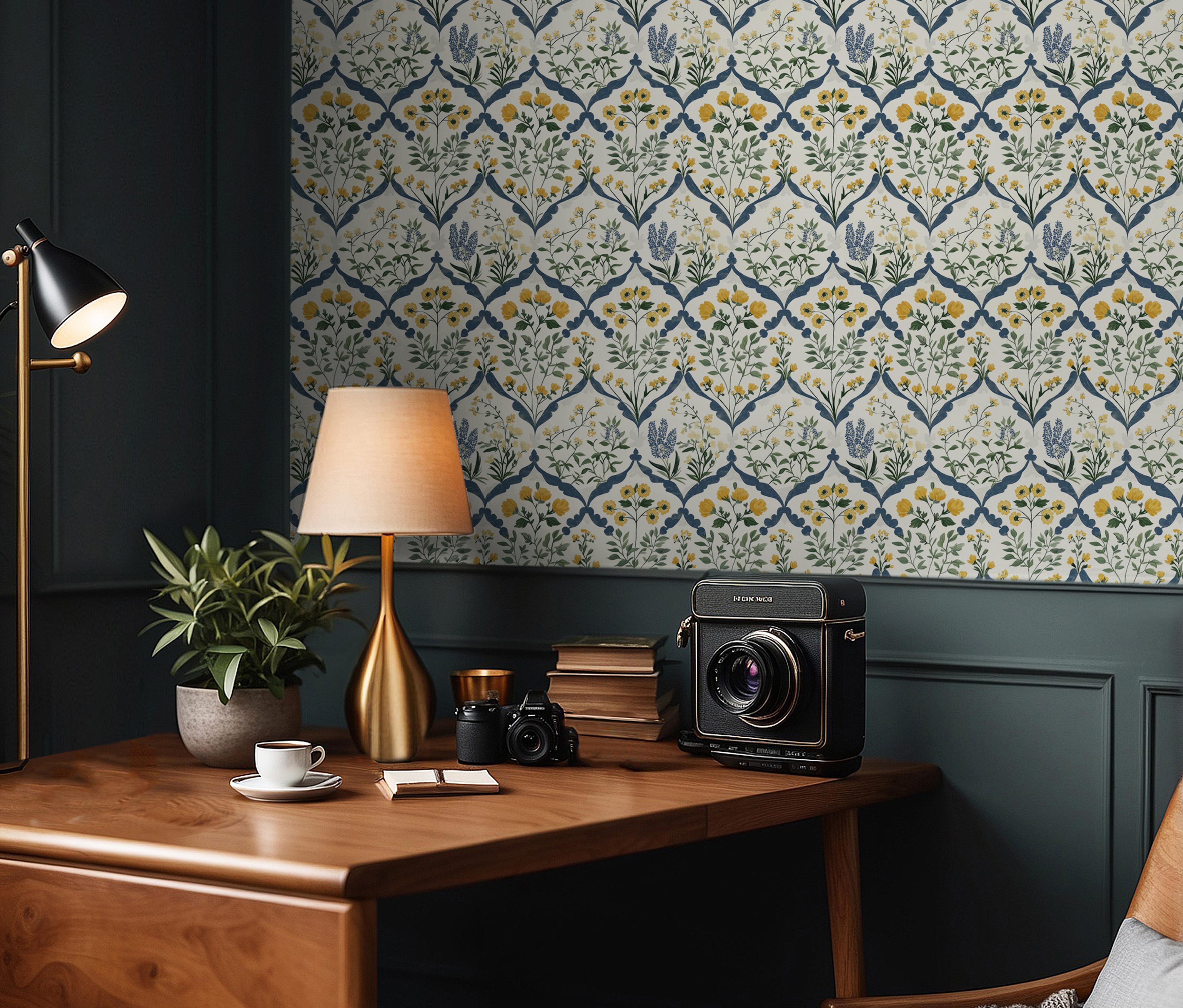Wallpaper 1966: Repeating damask-style wallpaper with yellow and blue flowers framed in a diamond pattern, shown in a cozy study with wood furniture and dark green paneling.