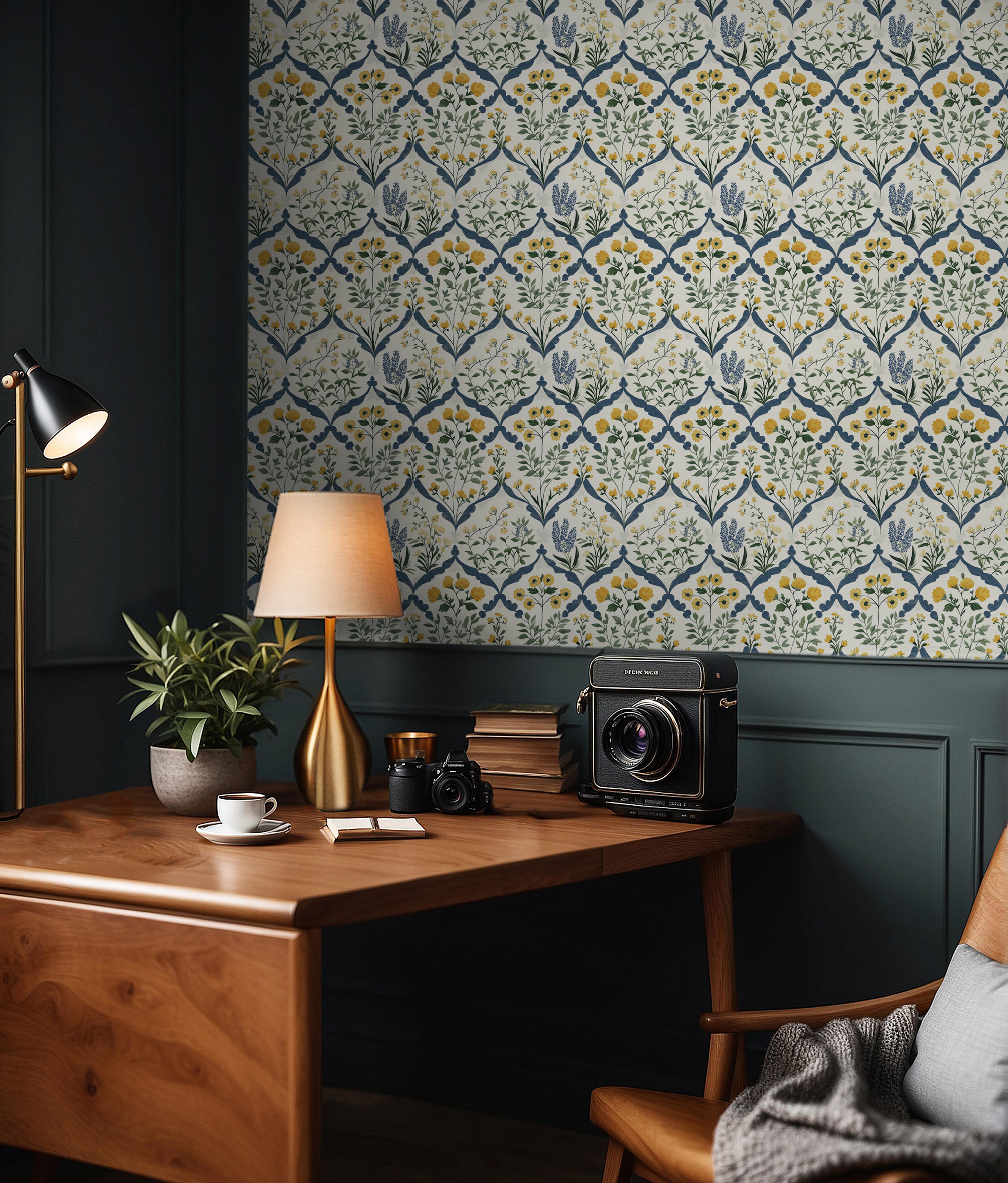 Wallpaper 1966: Repeating damask-style wallpaper with yellow and blue flowers framed in a diamond pattern, shown in a cozy study with wood furniture and dark green paneling.