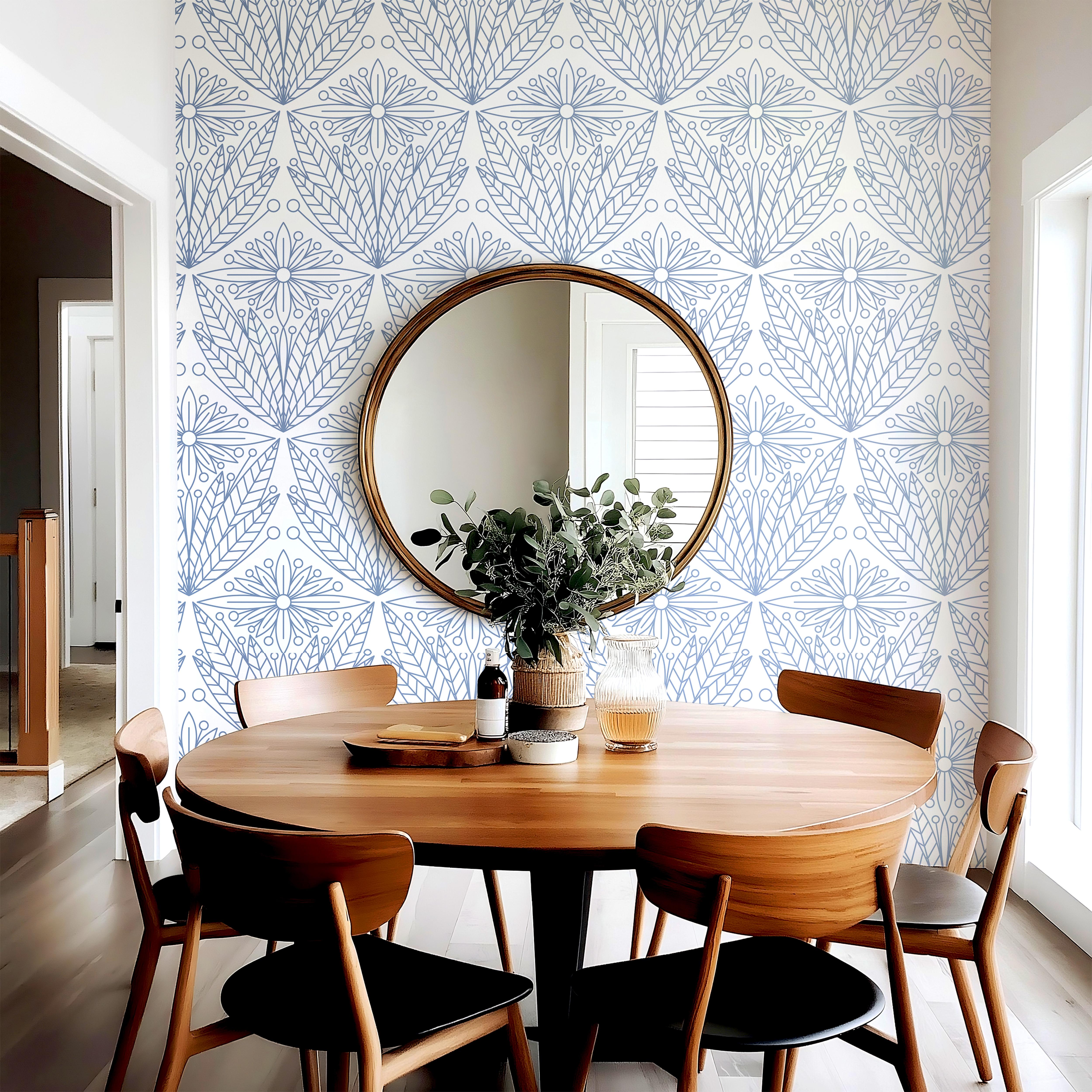Wallpaper 2010: Wallpaper with a clean white background and intricate blue floral-geometric designs, styled in a modern dining area with a round mirror, natural wood furniture, and soft Scandinavian decor.