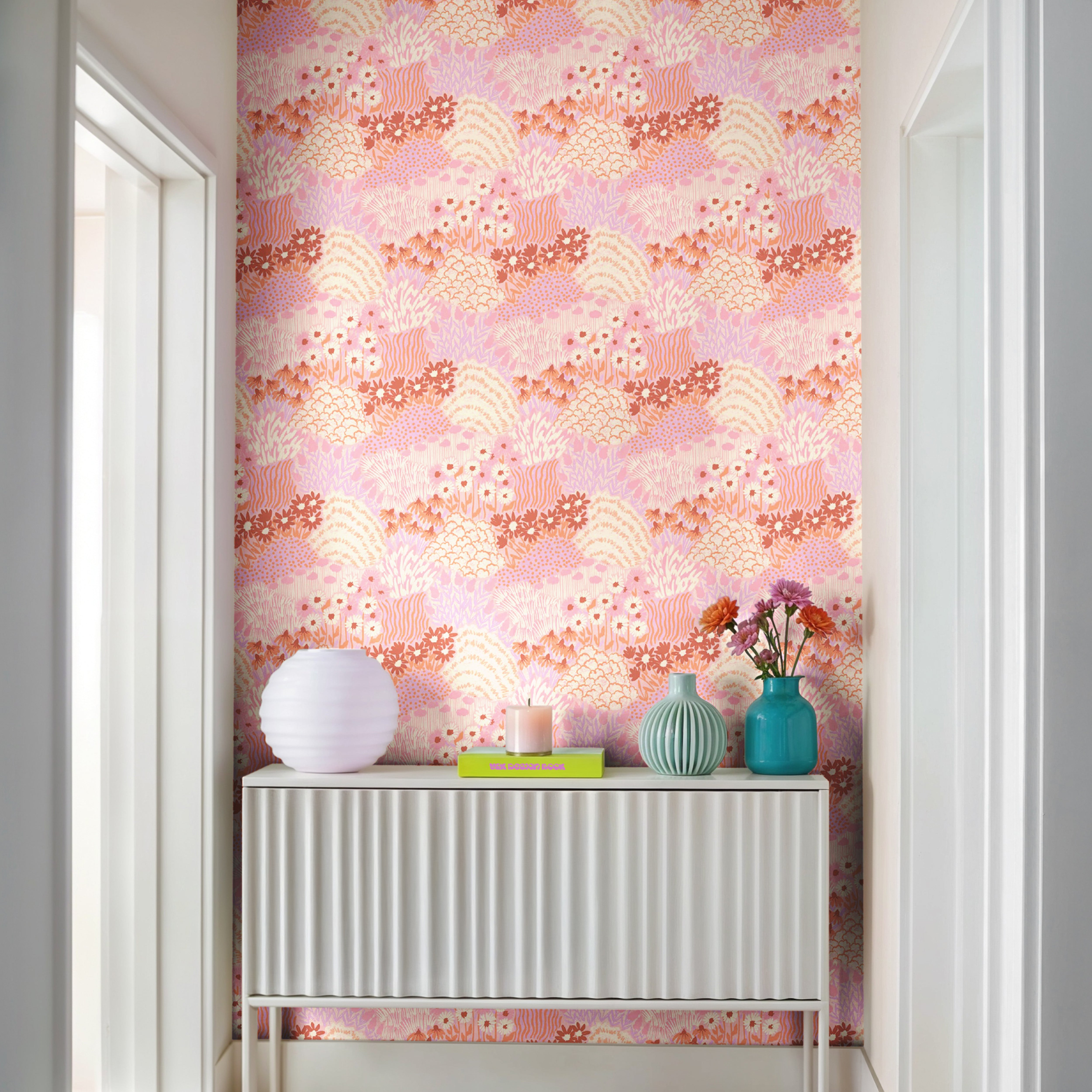 Close-up of Flowers in Her Hair wallpaper featuring layered botanical meadow flowers in blush, coral, peach, and lavender.