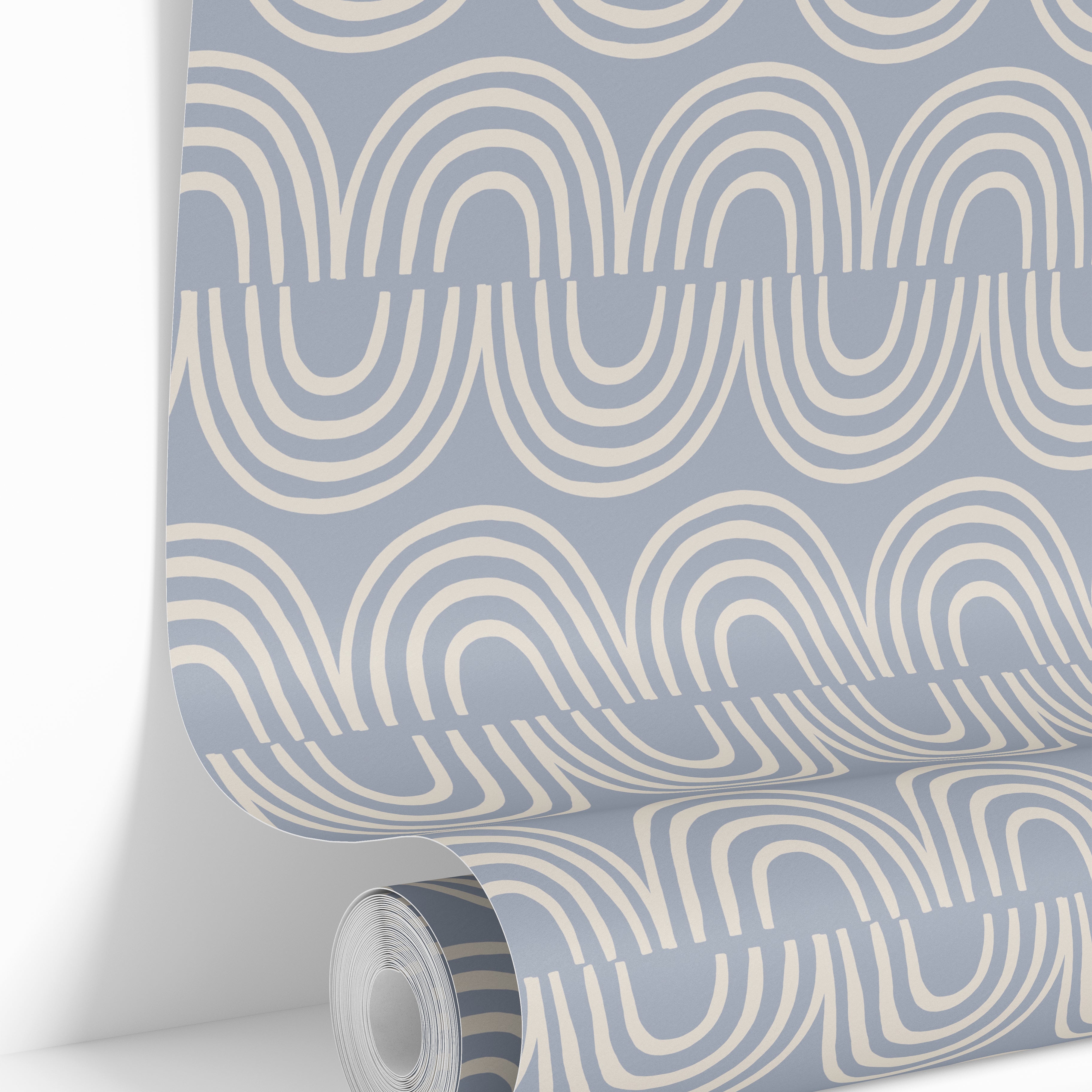 Roll of Harbor & Sky wallpaper displaying the repeating blue arch design printed in Michigan.