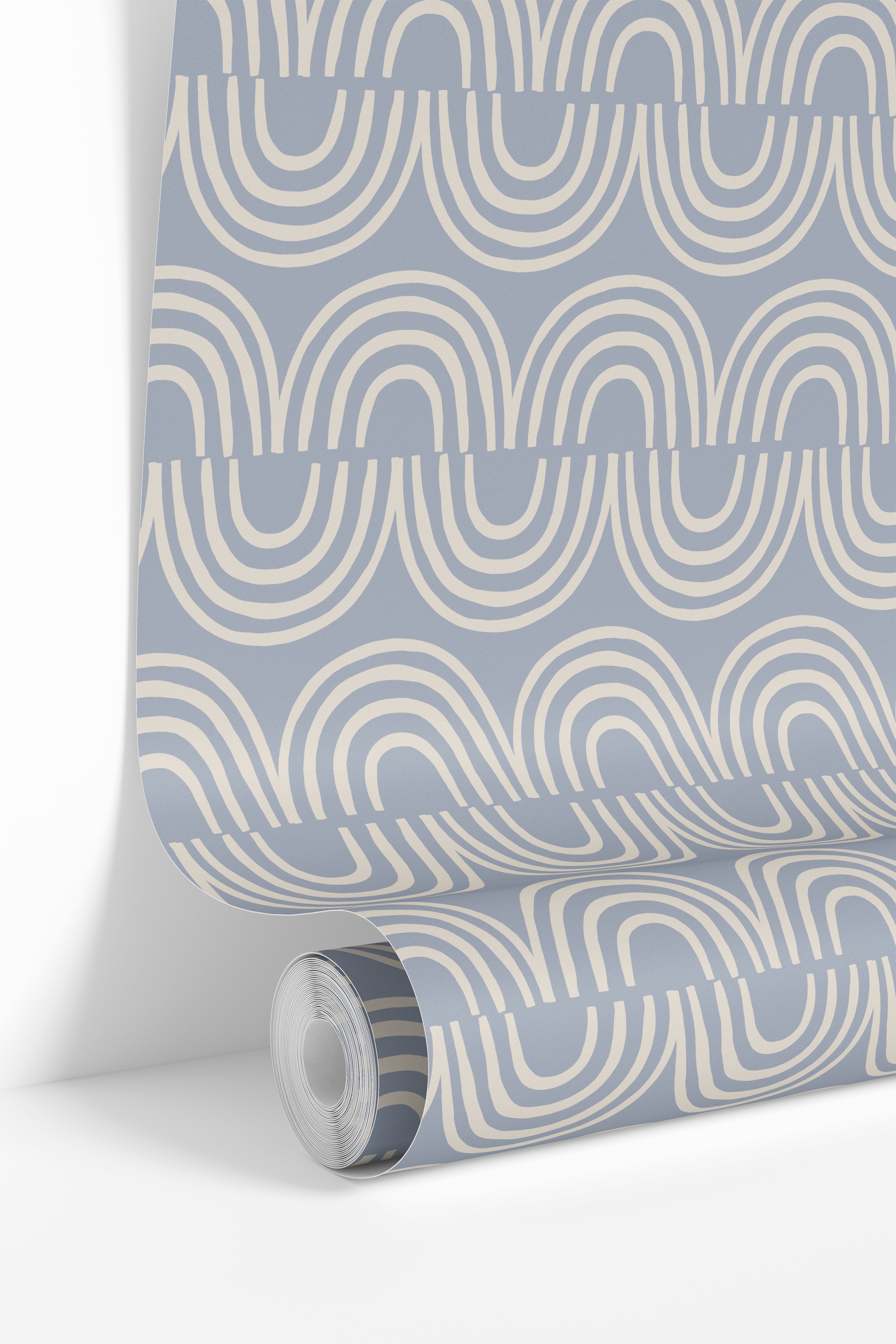 Roll of Harbor & Sky wallpaper displaying the repeating blue arch design printed in Michigan.
