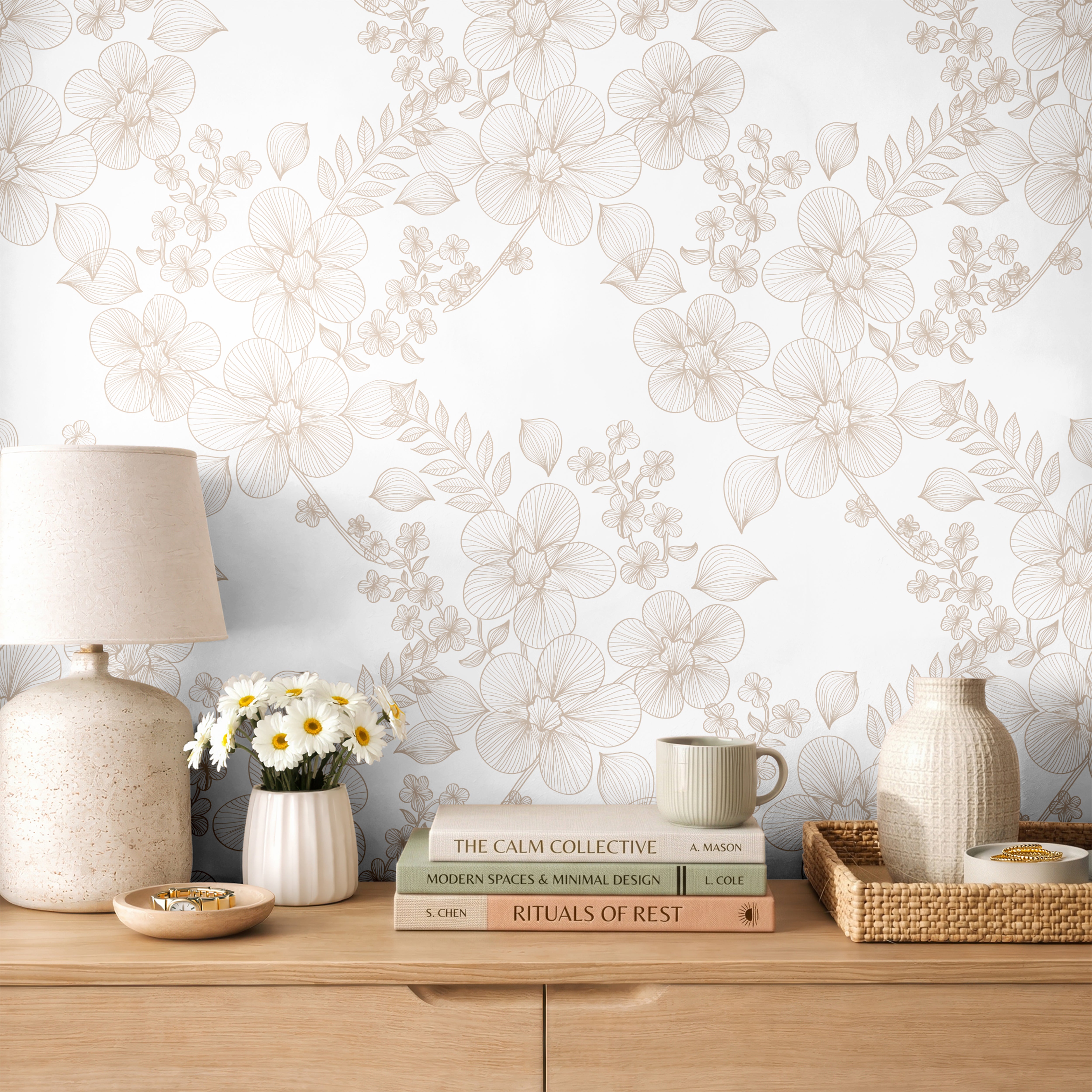 Lacewood House floral line art wallpaper styled above a light wood dresser with woven and botanical décor