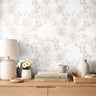 Lacewood House floral line art wallpaper styled above a light wood dresser with woven and botanical décor