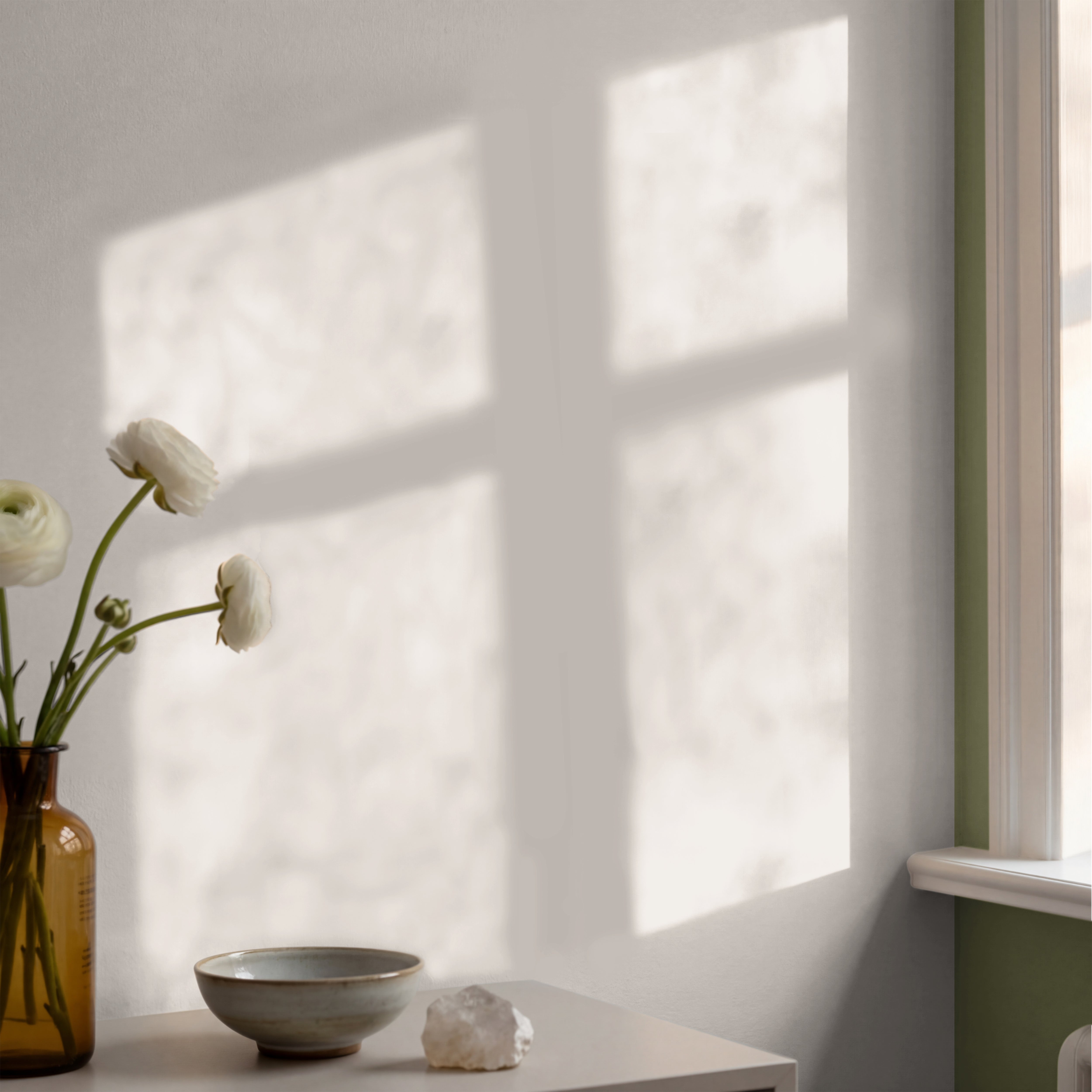 Ivory House solid ivory wallpaper in a peaceful dining room with white and cream furnishings.