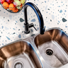 Countertop film 51: A stylish kitchen countertop covered in a white and blue terrazzo-patterned adhesive film, featuring a modern design with scattered stone-like flecks for a contemporary look.