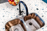 Countertop film 51: A stylish kitchen countertop covered in a white and blue terrazzo-patterned adhesive film, featuring a modern design with scattered stone-like flecks for a contemporary look.