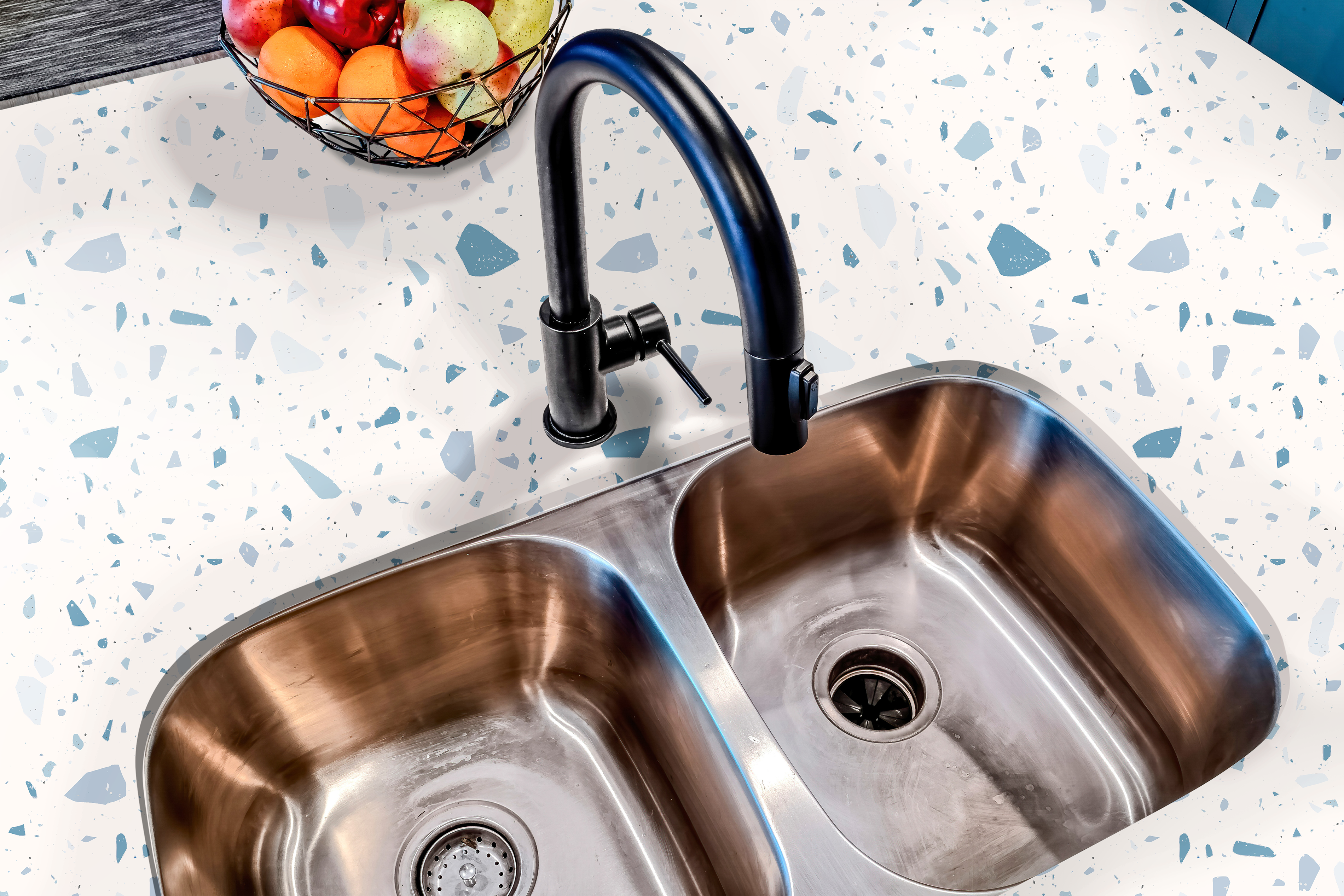 Countertop film 52: A modern kitchen countertop covered in blue terrazzo contact paper, featuring a speckled pattern of blue and white stone-like fragments. 