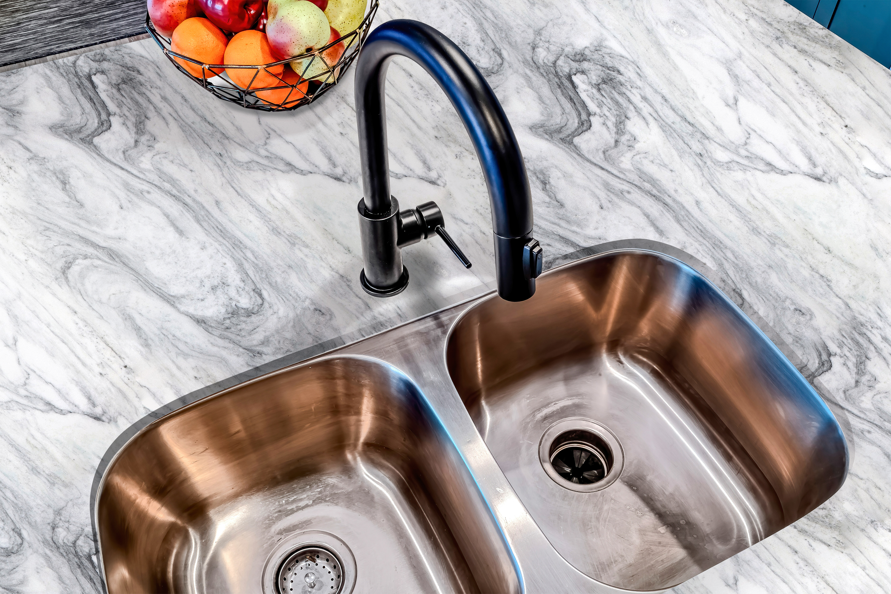 Countertop 53: A realistic white marble countertop film with gray veining, applied around a kitchen sink. The waterproof, adhesive wrap enhances the countertop with a sleek, elegant finish.