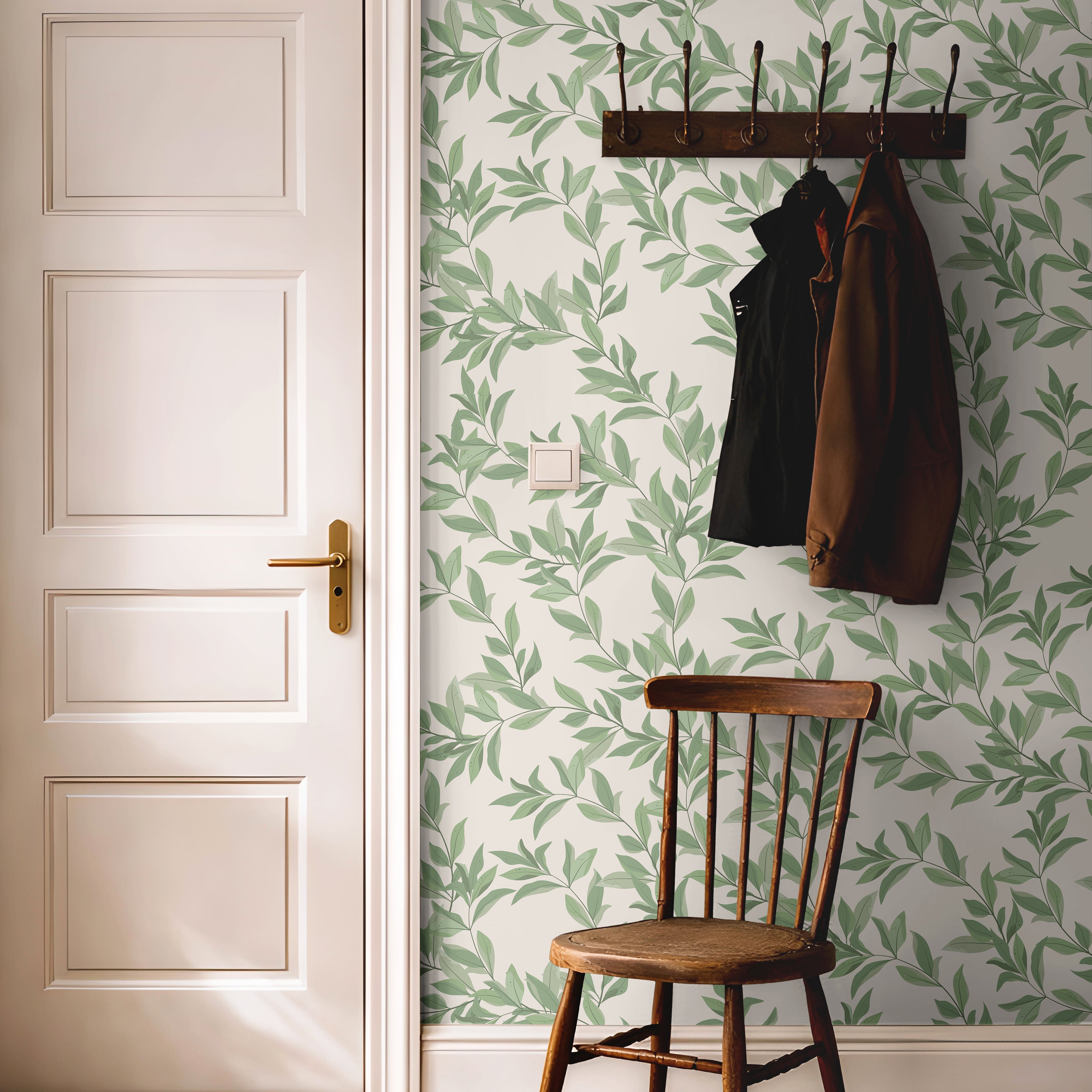 Bright green airy leaves styled with dark wood accents in a warm hallway