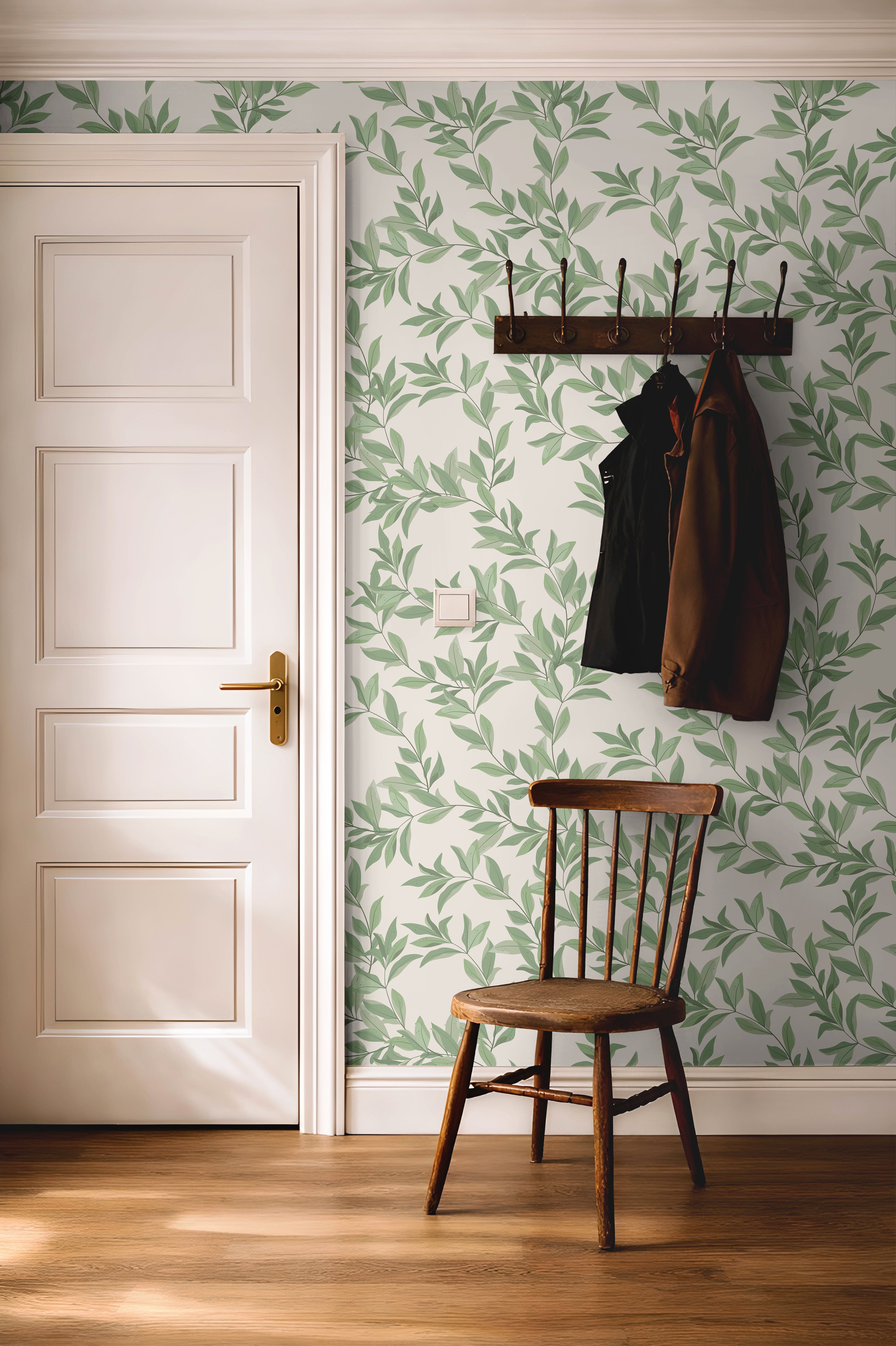 Bright green airy leaves styled with dark wood accents in a warm hallway