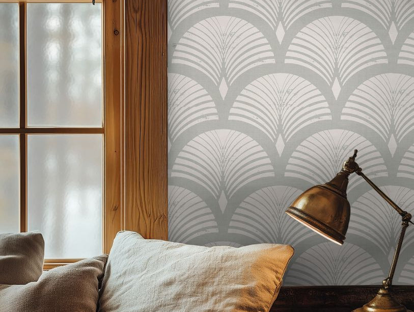 Warm reading corner with Ariscroft Taupe Geometric Wallpaper, brass lamp, and soft neutral pillows