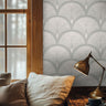 Warm reading corner with Ariscroft Taupe Geometric Wallpaper, brass lamp, and soft neutral pillows