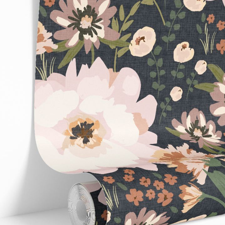 Luxury floral wallpaper roll with painterly blush and ivory flowers on a deep navy background