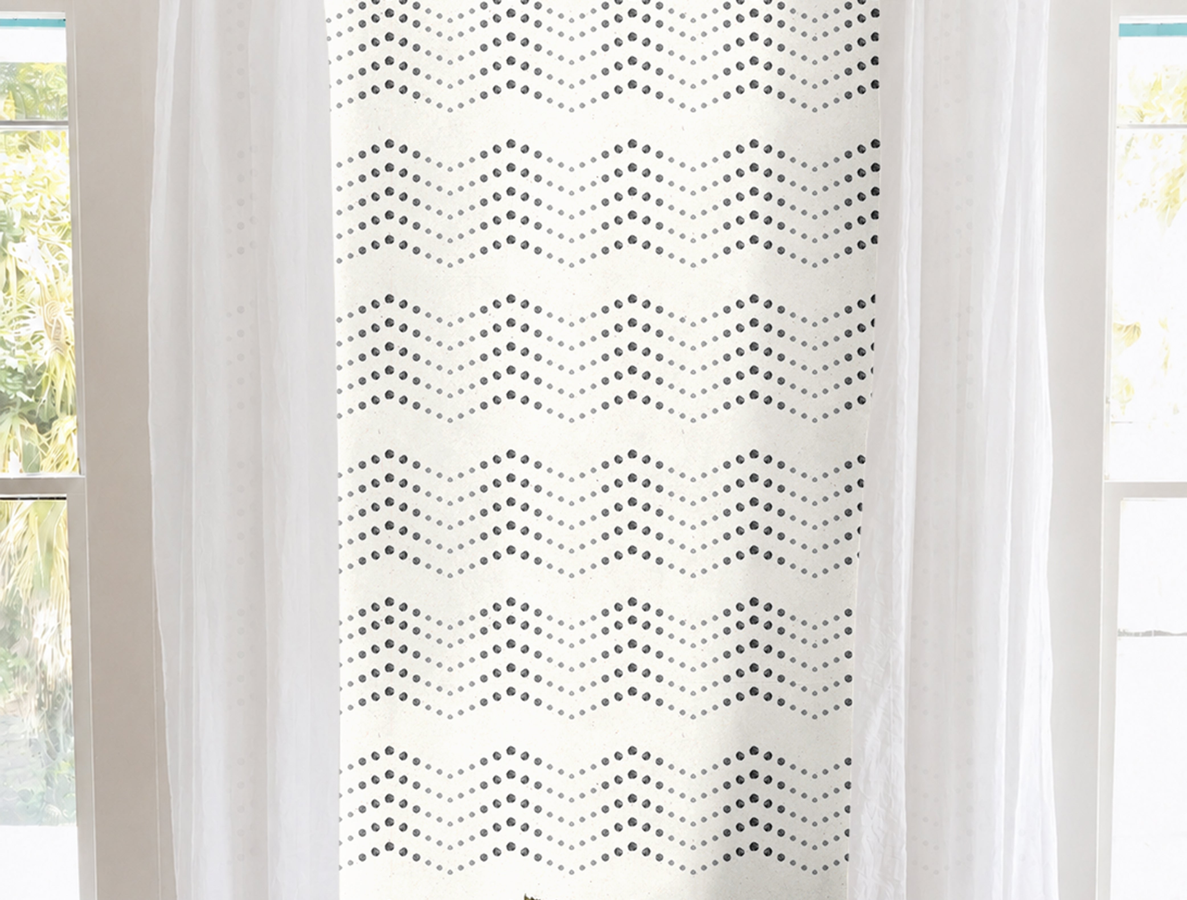 Cream background with black dotted chevron geometrical patterns in modern white living room