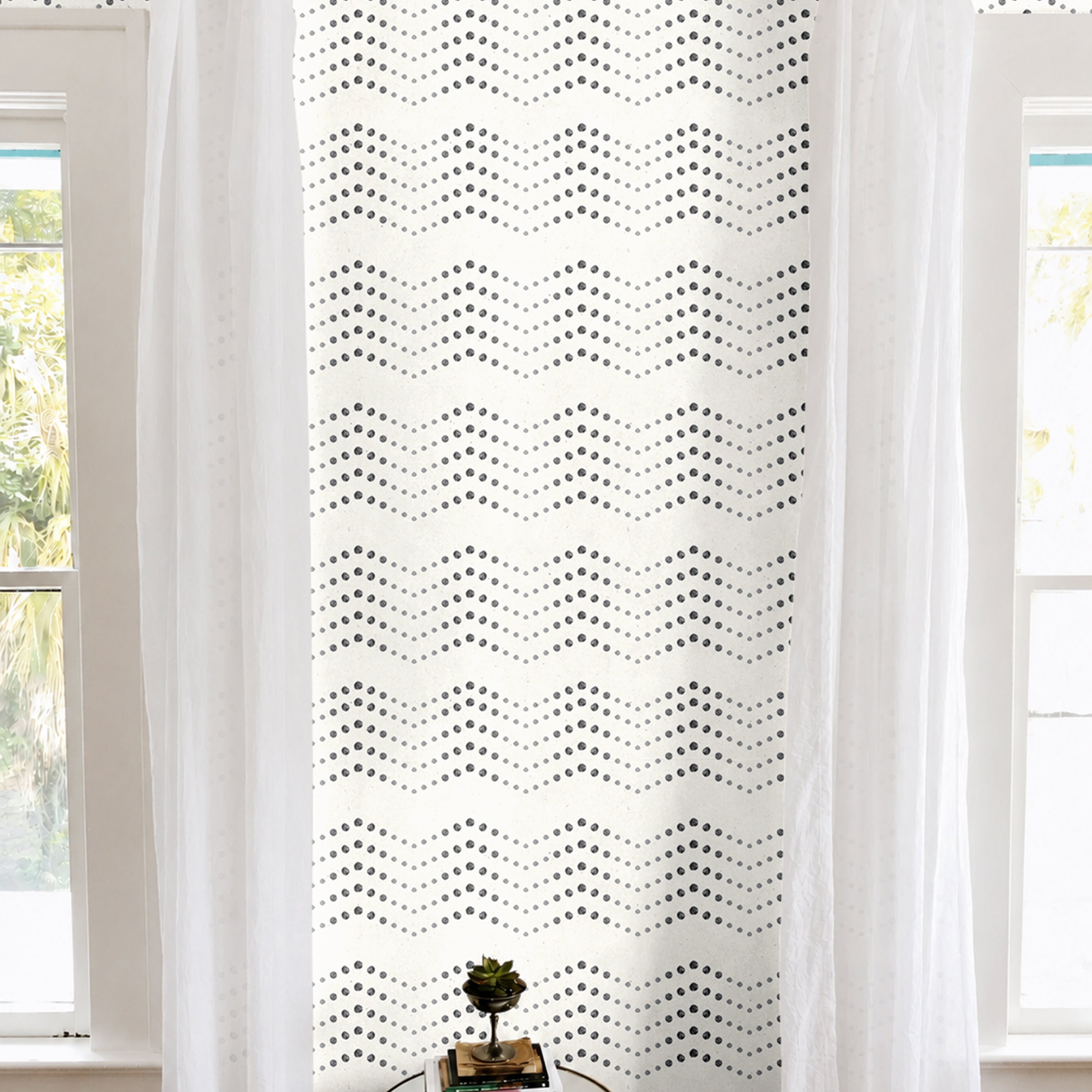 Cream background with black dotted chevron geometrical patterns in modern white living room