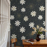Black and white daisies with golden accents on black background in living space