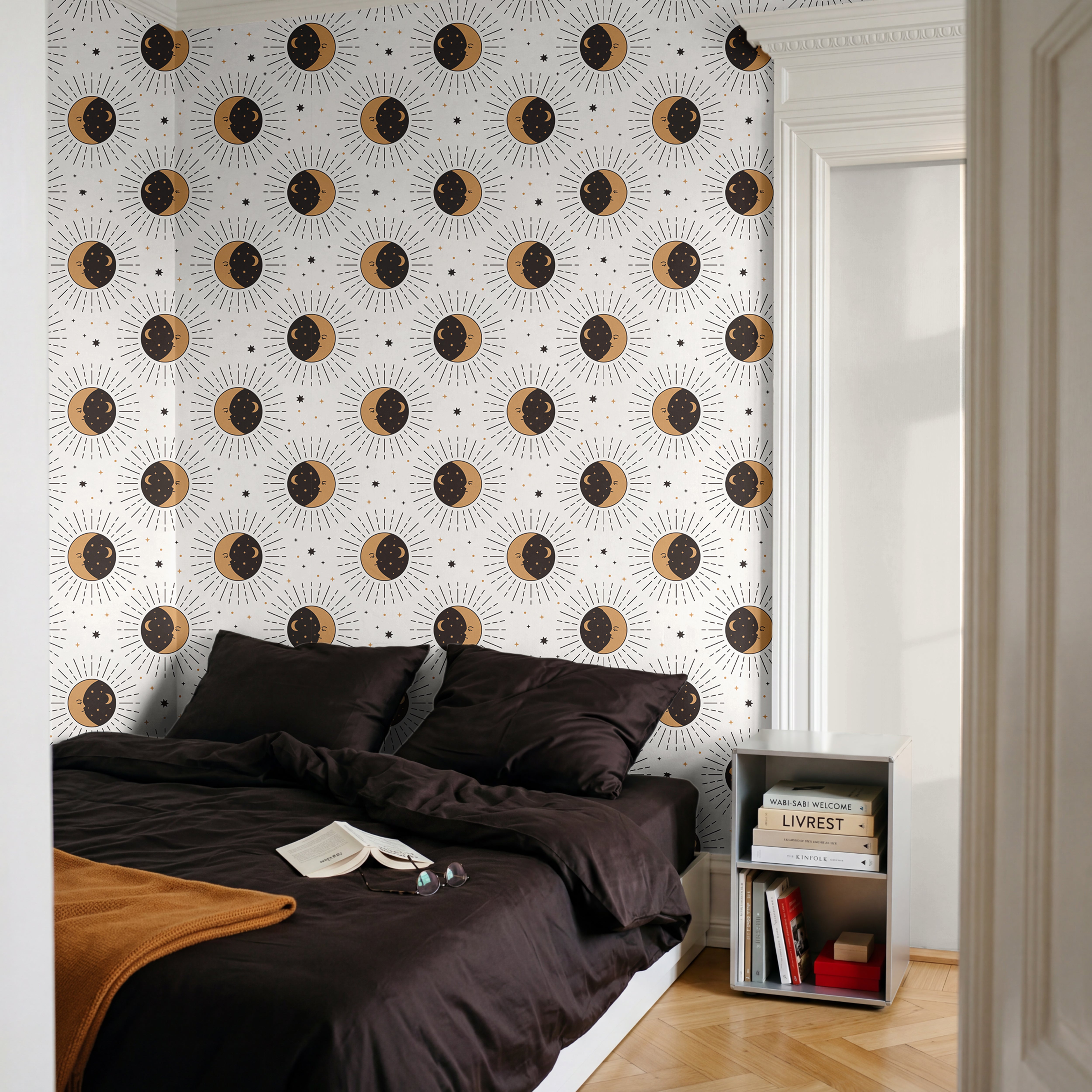 Celestial gold and black sun and moons on white background in modern black and white bedroom
