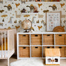 boho brown dinosaurs with mountains and volcanos and bones in kids nursery play room with cube shelf and wicker baskets 