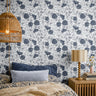classic floral wallpaper in deep navy set against a soft cream background