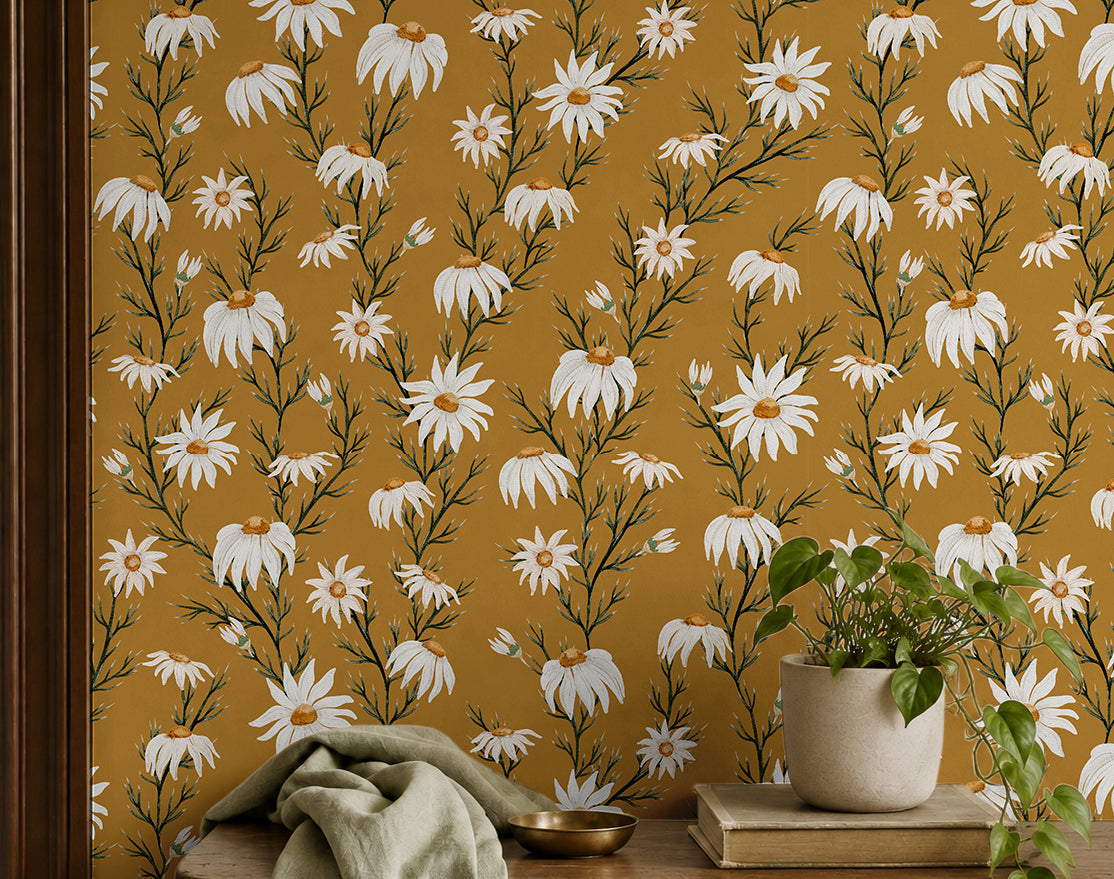 wallpaper with white daisies on a golden yellow background behind entryway shelf