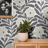stunning fusion of oversized floral elements and organic sprigs in a sophisticated black-and-beige palette