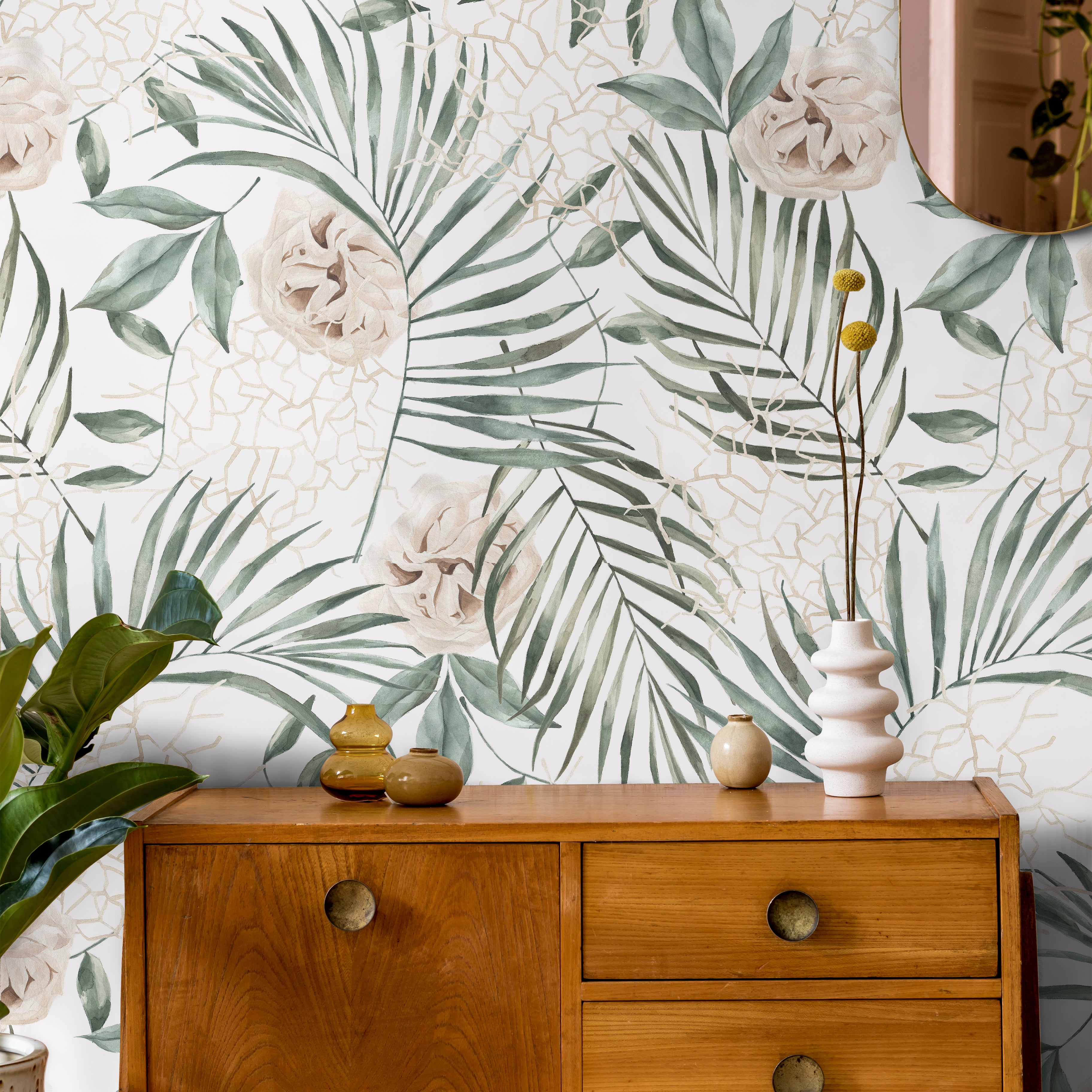 Tropical palm leaves with white background in living area styled with warm wooden accents