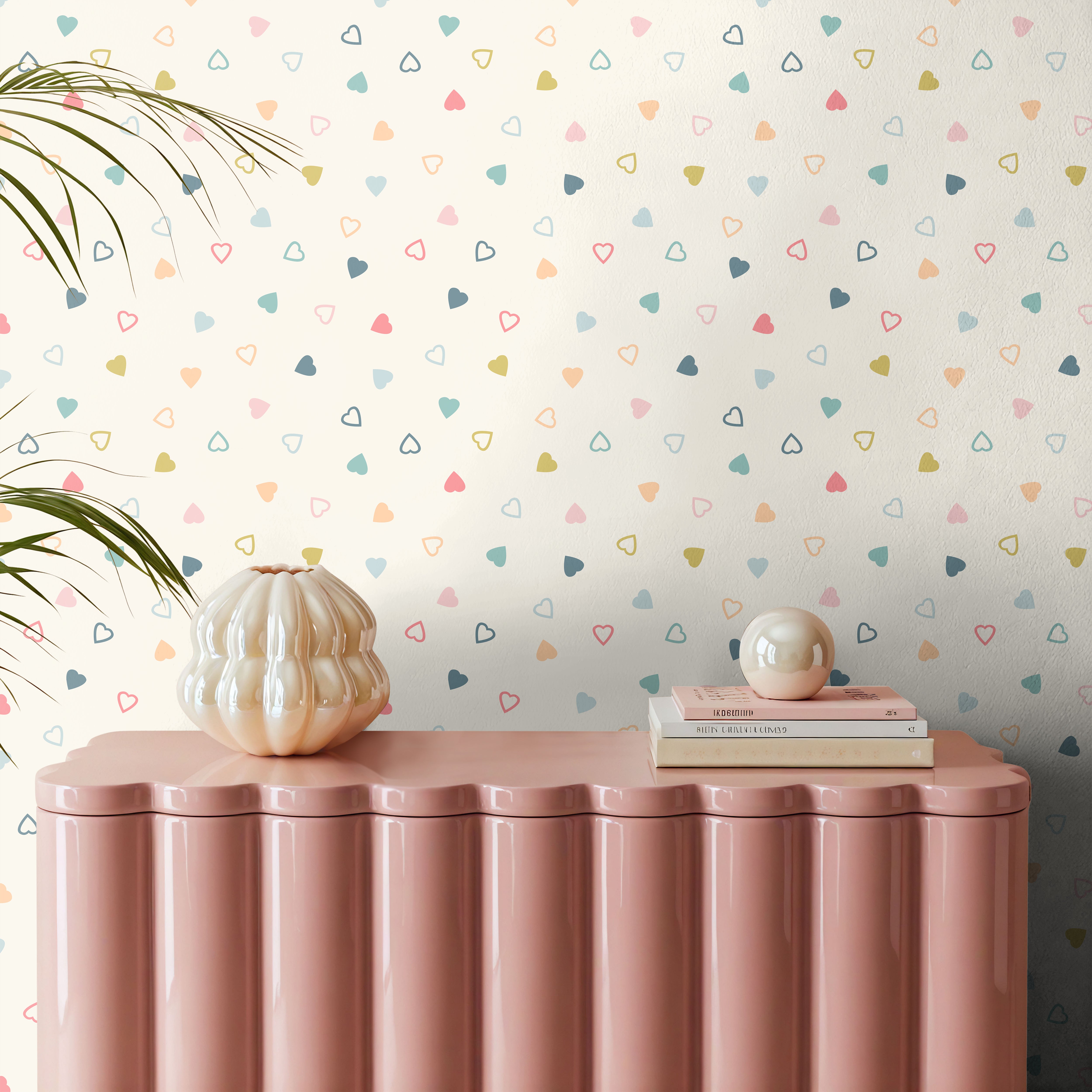 Ivory white background with multi colored hearts some outlines and some filled in behind a pink credenza with pearl accents