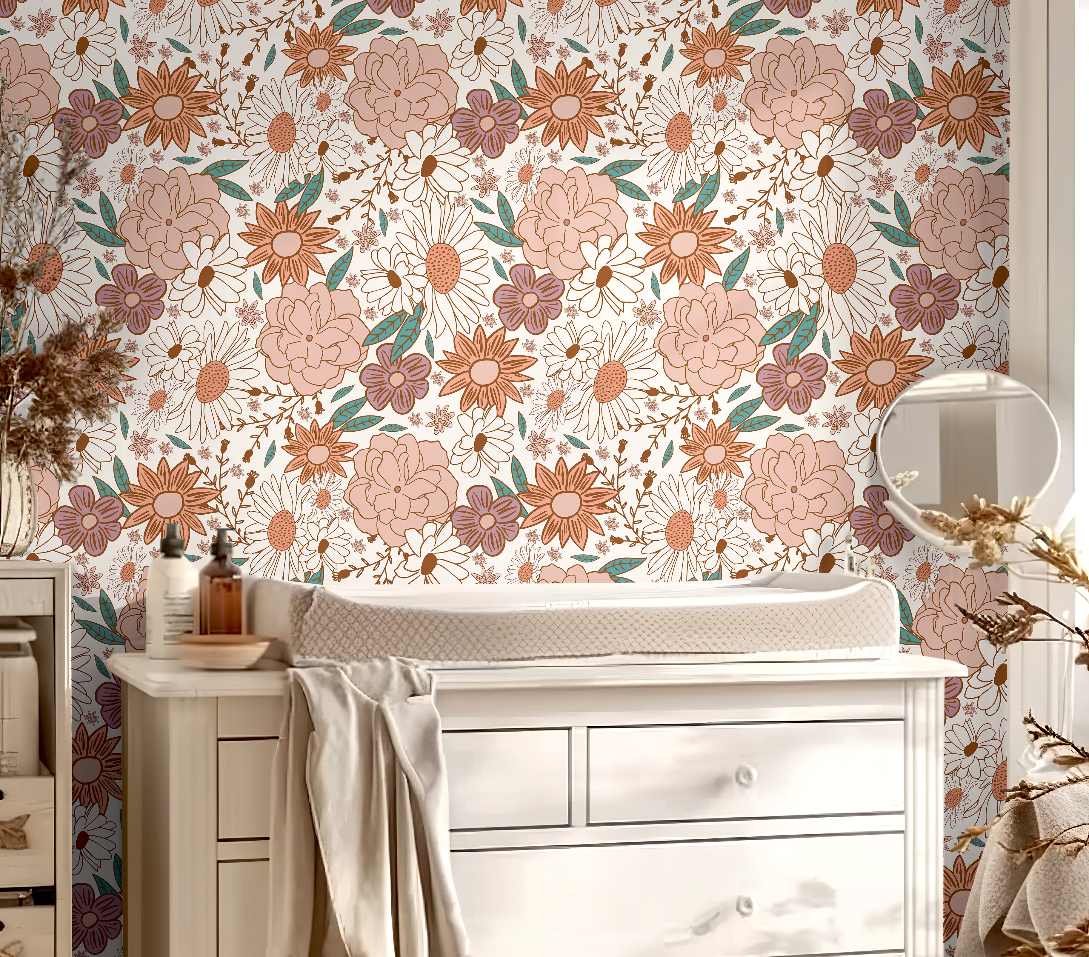 Muted pink floral wall covering styled with white nursery decor