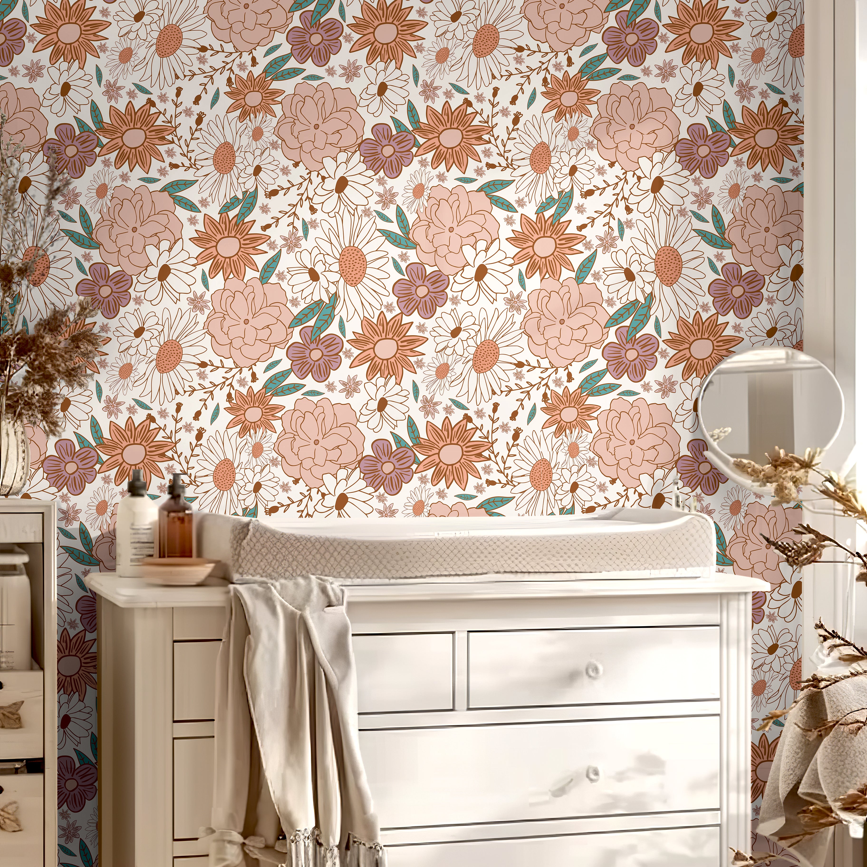 Muted pink floral wall covering styled with white nursery decor