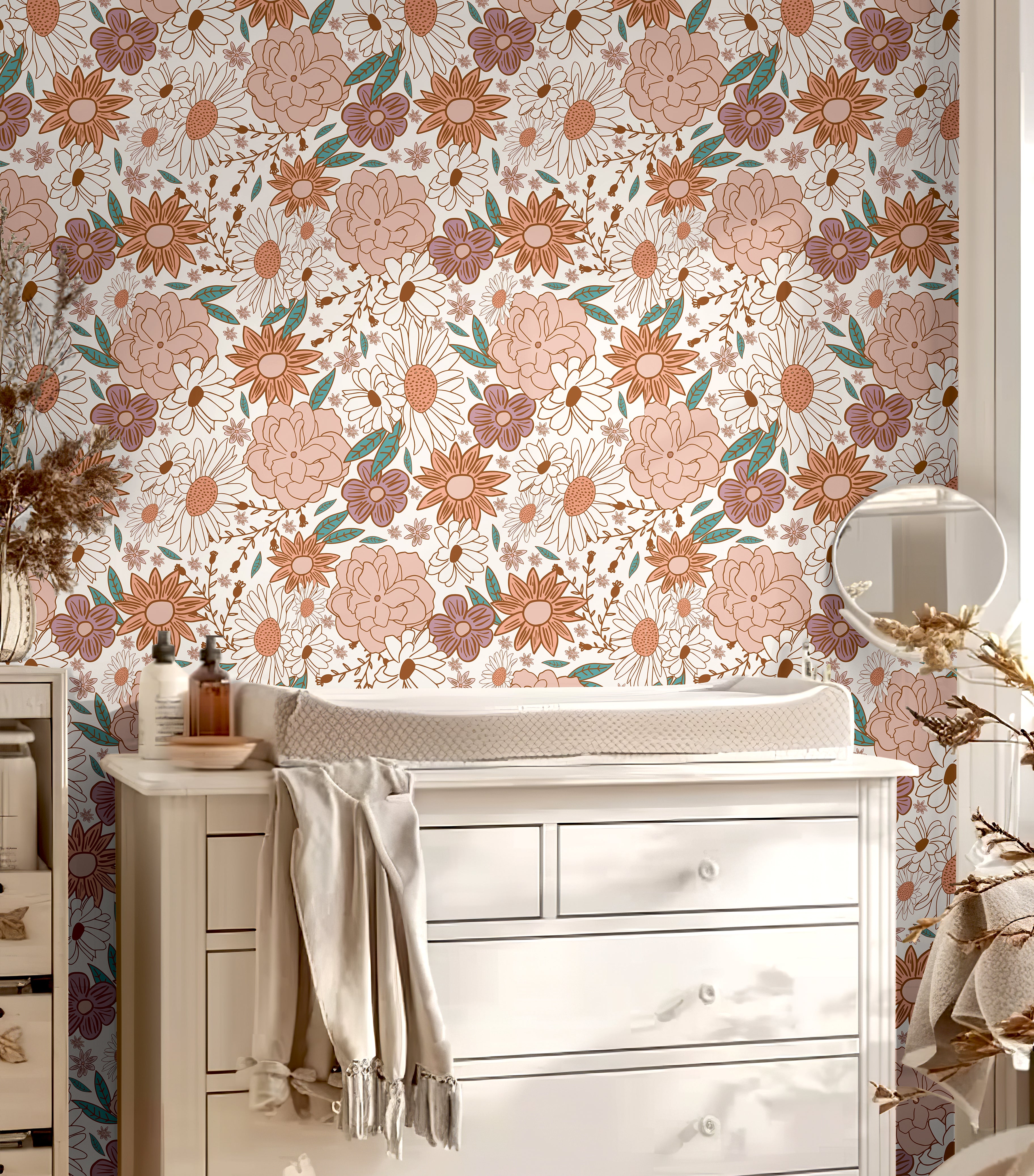 Muted pink floral wall covering styled with white nursery decor