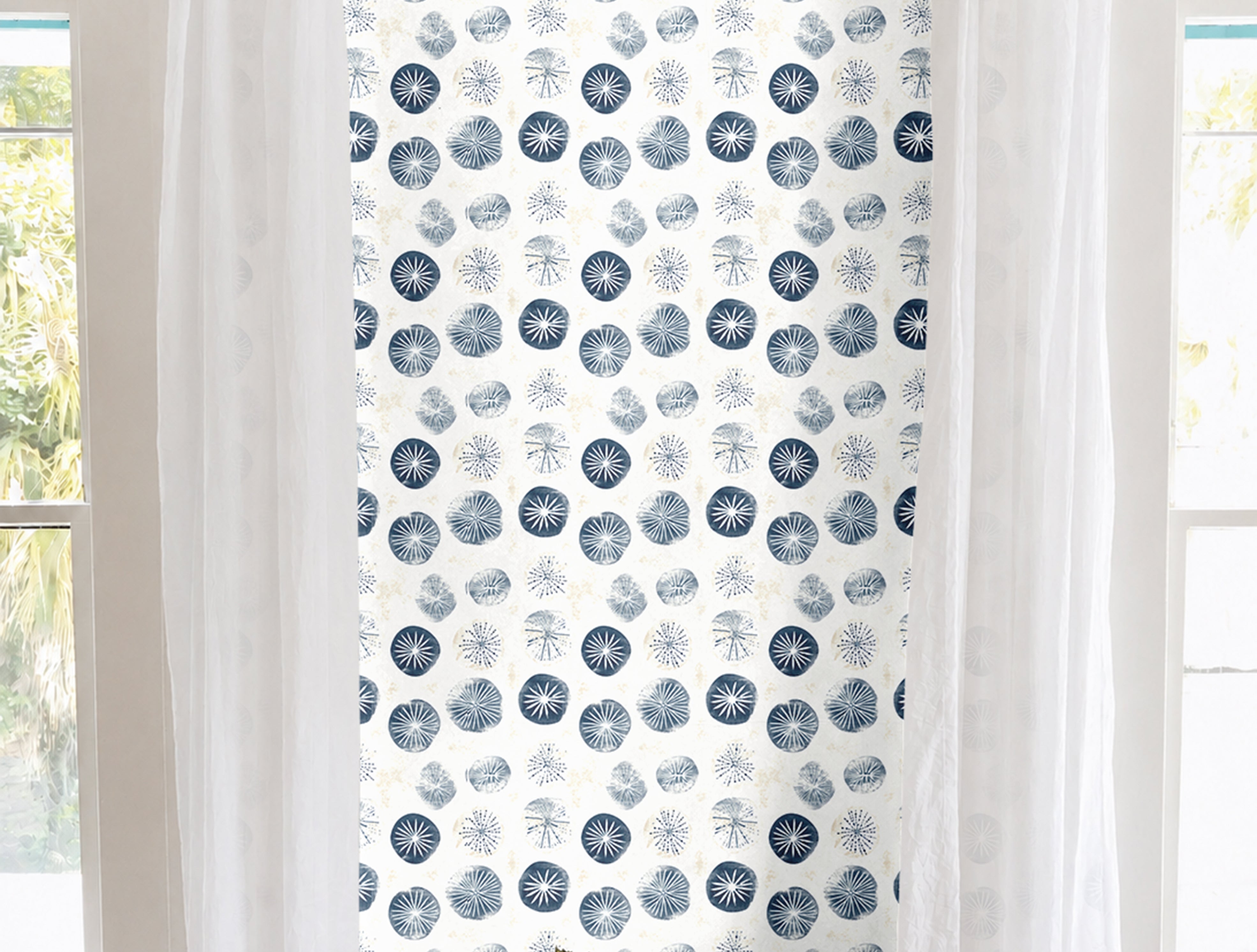 Navy and white sand dollar geometric print in brightly lit white living room
