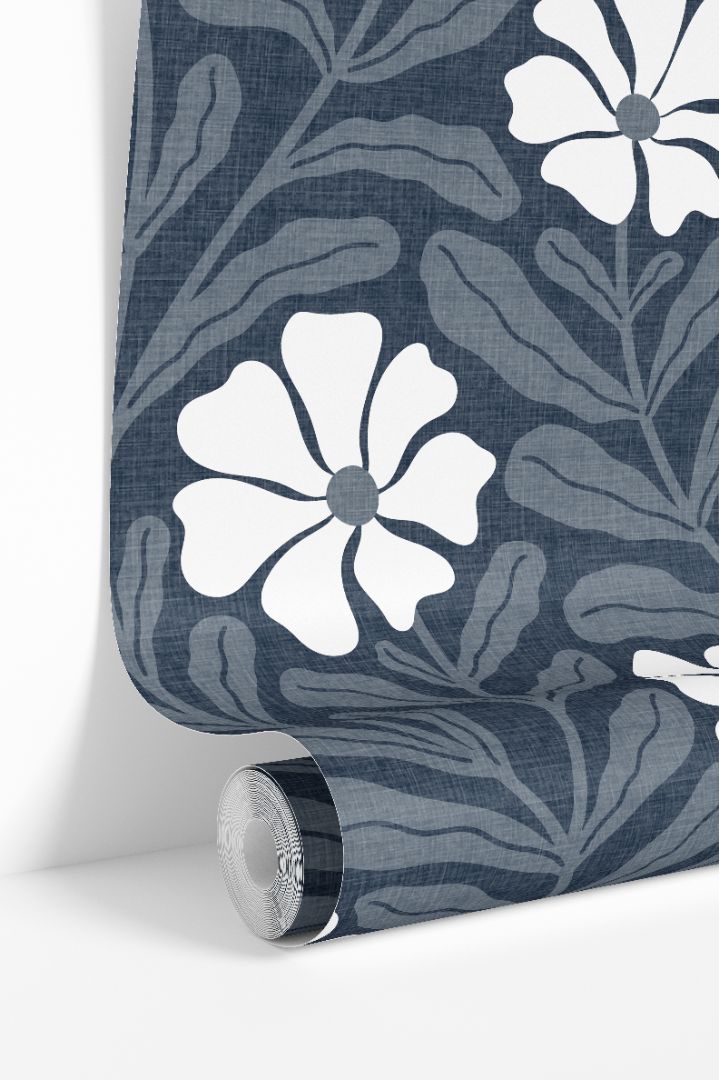 Luxury blue wallpaper roll with graphic white floral shapes and layered botanical background