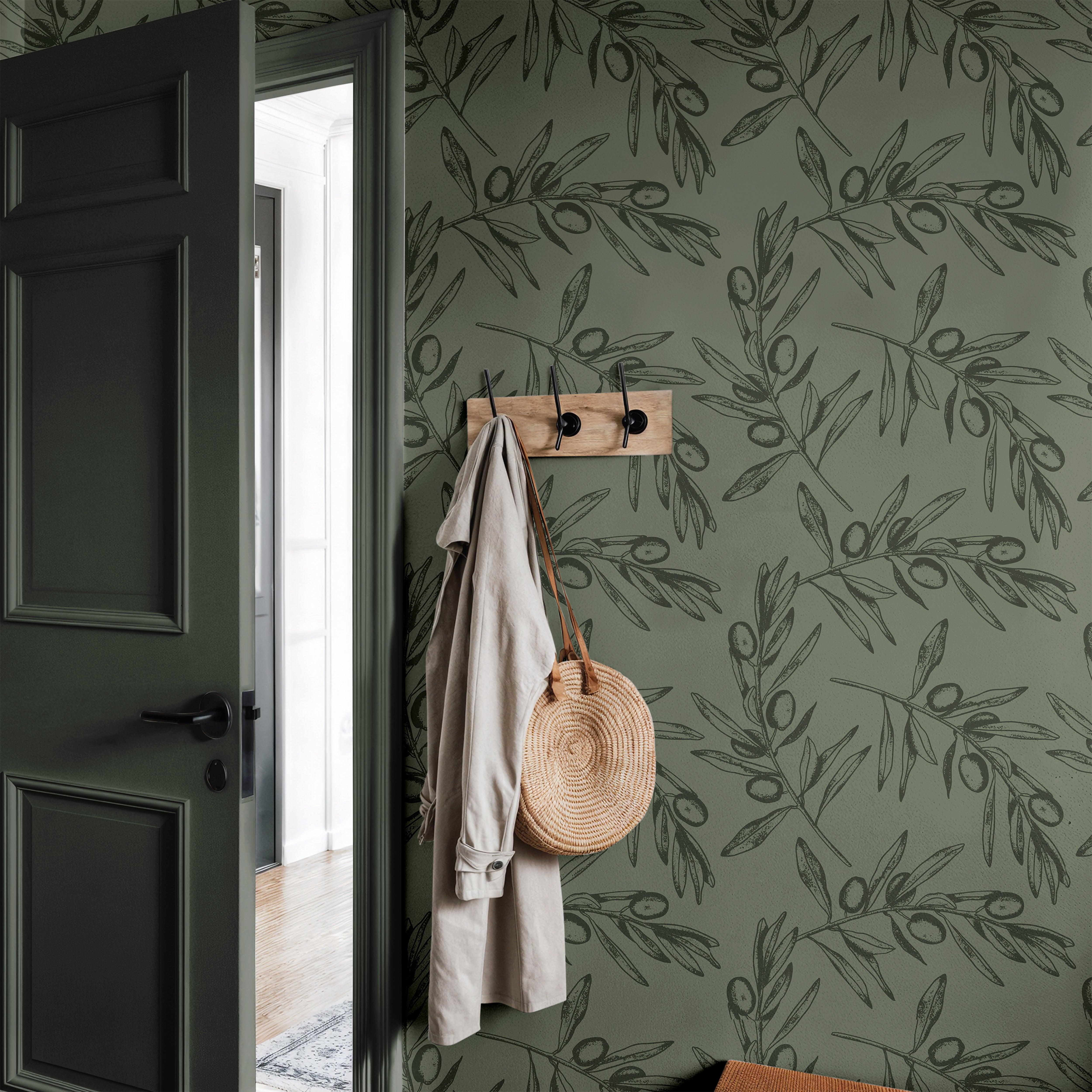 Dark green olive branches in entryway with dark green door
