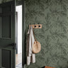 Dark green olive branches in entryway with dark green door