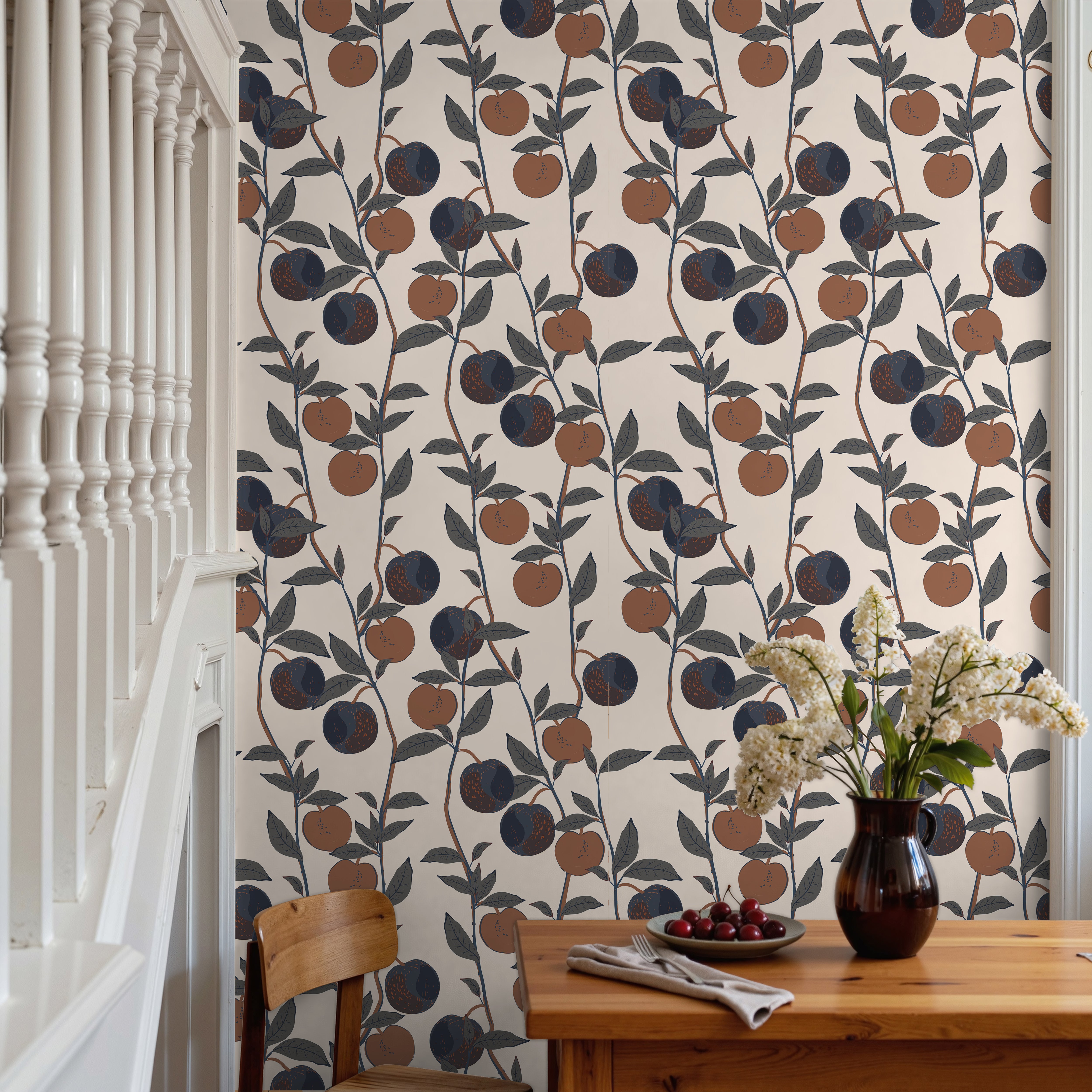 warm terracotta oranges, deep navy plums, charcoal foliage, and a soft cream background, creating a welcoming cottage-inspired atmosphere