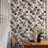 warm terracotta oranges, deep navy plums, charcoal foliage, and a soft cream background, creating a welcoming cottage-inspired atmosphere