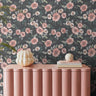 Stamped pink and white florals on dark green in bright interior