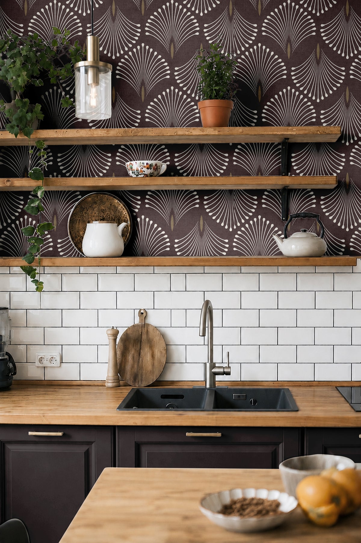 Port & Pin plum and ivory fan wallpaper behind wood kitchen shelves, white tile and dark cabinetry.